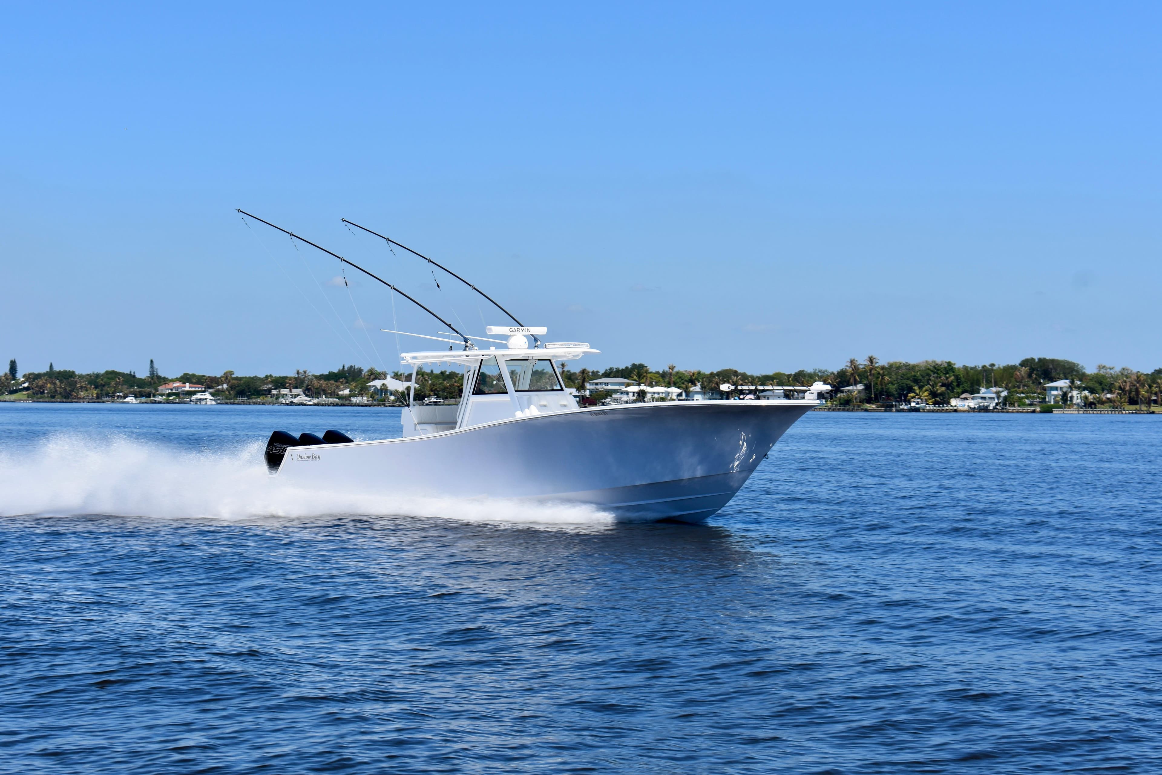 2022 Onslow Bay 41 Tournament boat cruising on open water under clear blue sky.