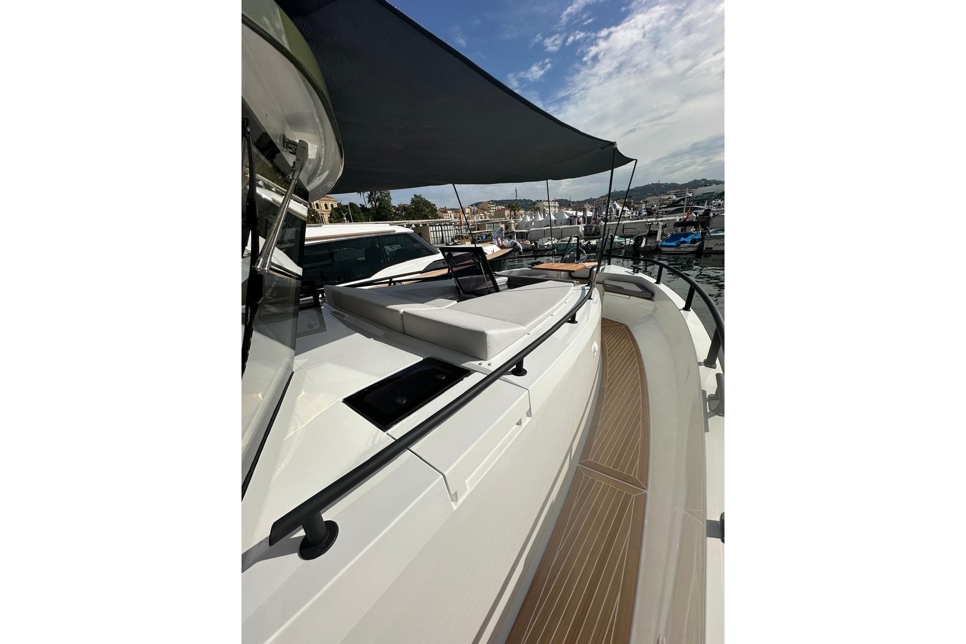 2025 Sargo 45 yacht with sunshade, docked at marina under partly cloudy sky.