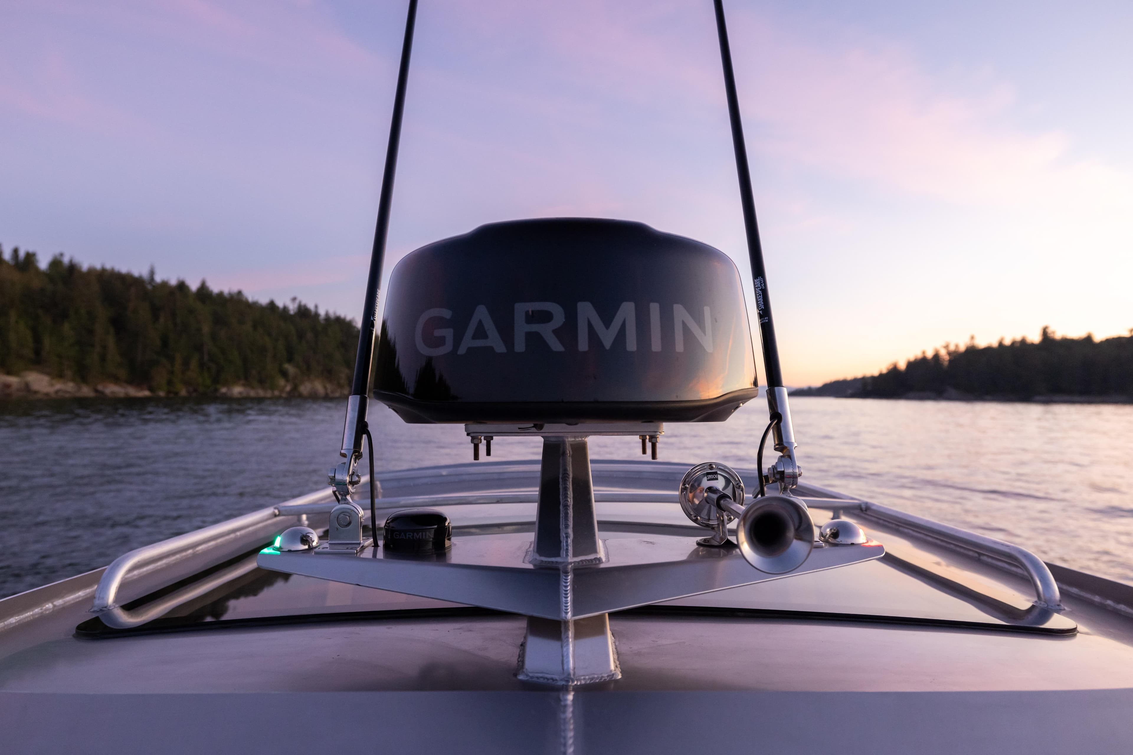 Bow view of 2026 Jasper Marine Defender 22 with Garmin equipment at sunset.