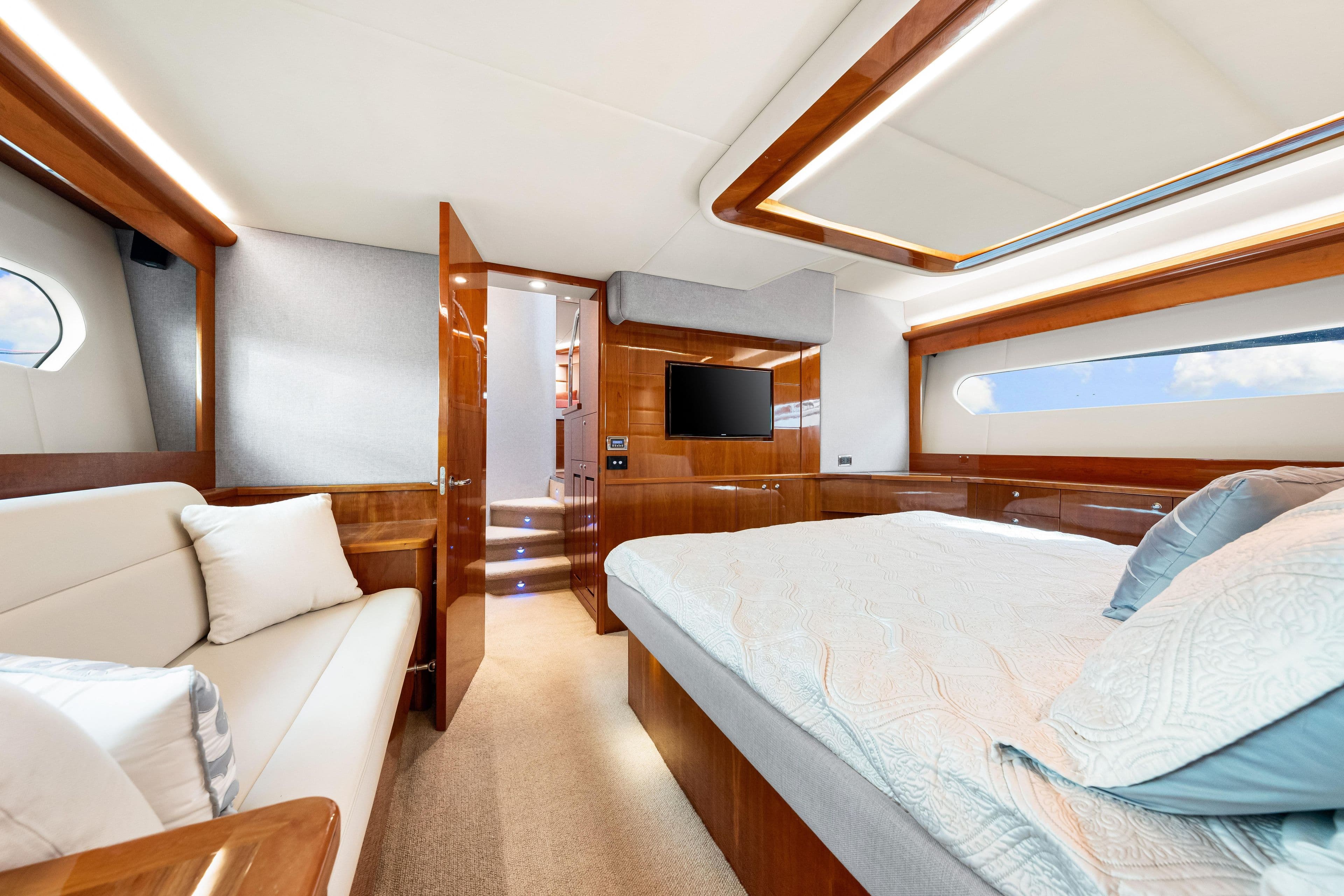 Luxurious interior of 2015 Riviera 565 SUV yacht with elegant wood finishes and modern amenities.