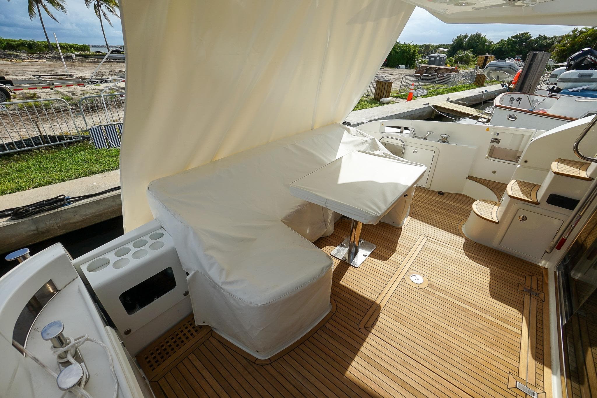 2014 Azimut 54 Flybridge yacht deck with seating, table, and wooden flooring.