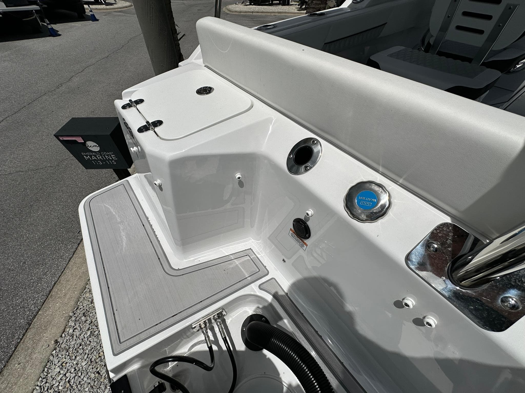 2024 Blackfin 232 DC boat deck with seating and storage compartments.