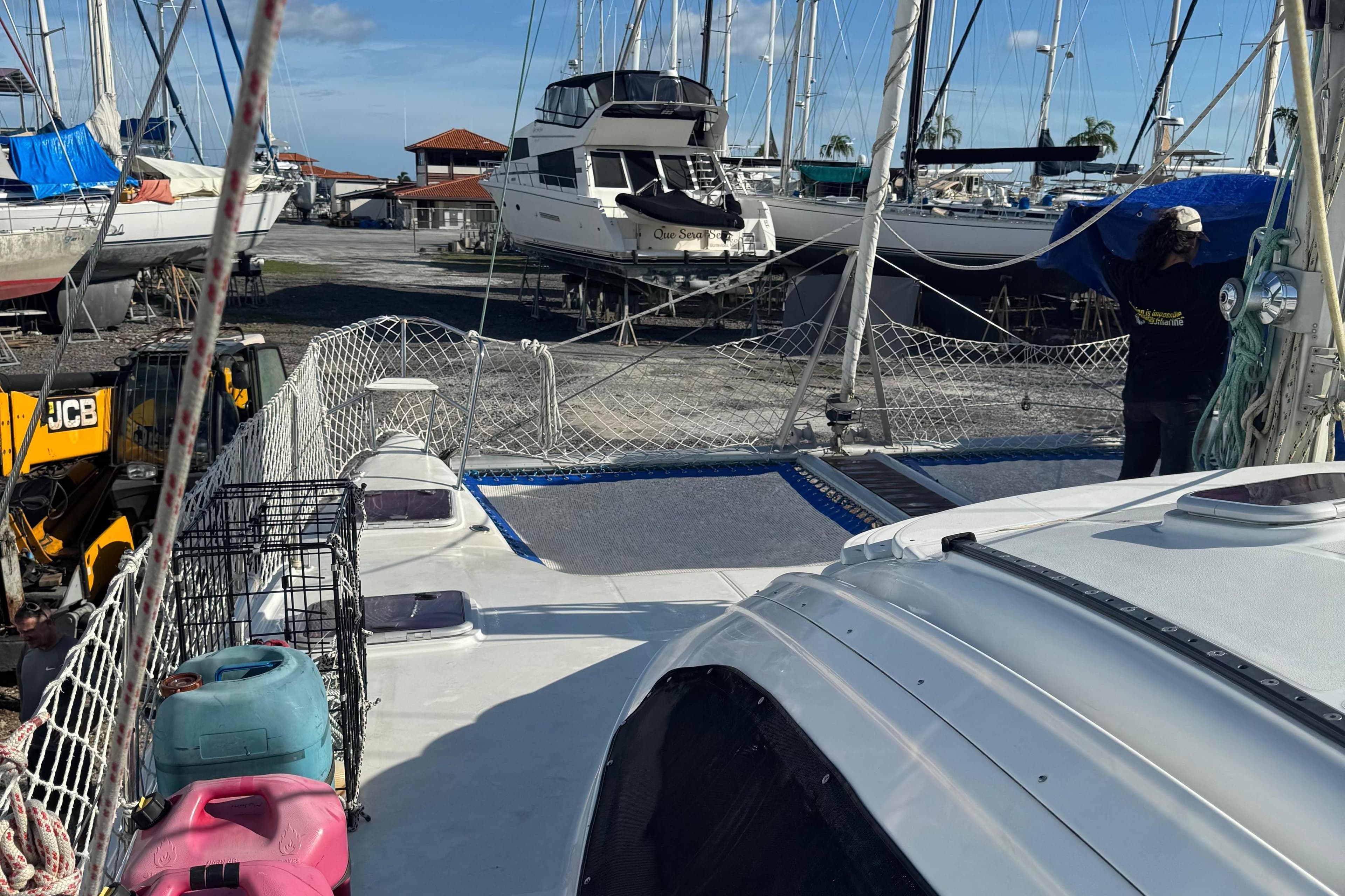 2005 Fortuna Island Spirit 401 catamaran in a boatyard, surrounded by other vessels.