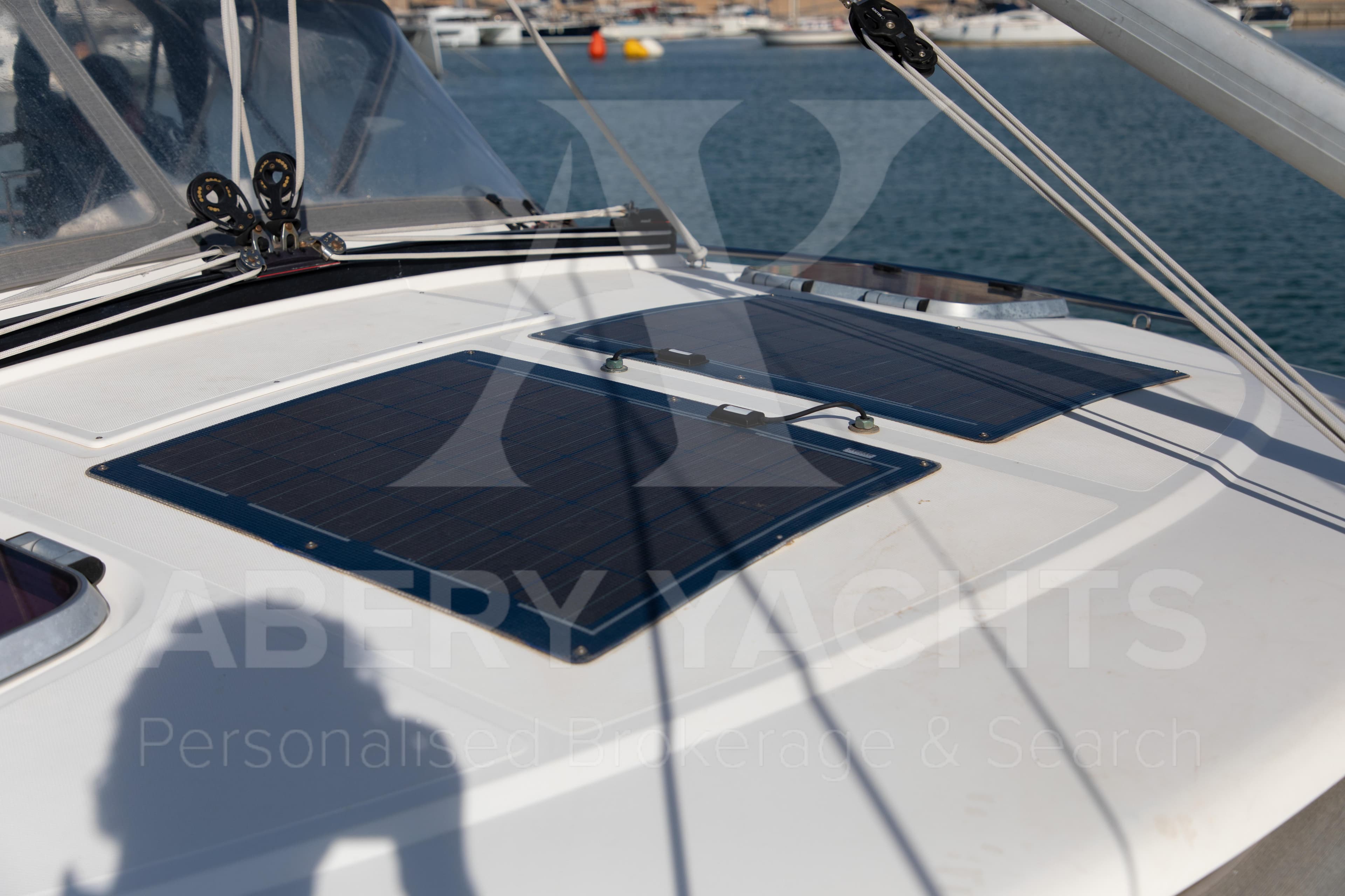 Sailboat deck with solar panels, Nauticat 525, 2010 model, docked in a marina.