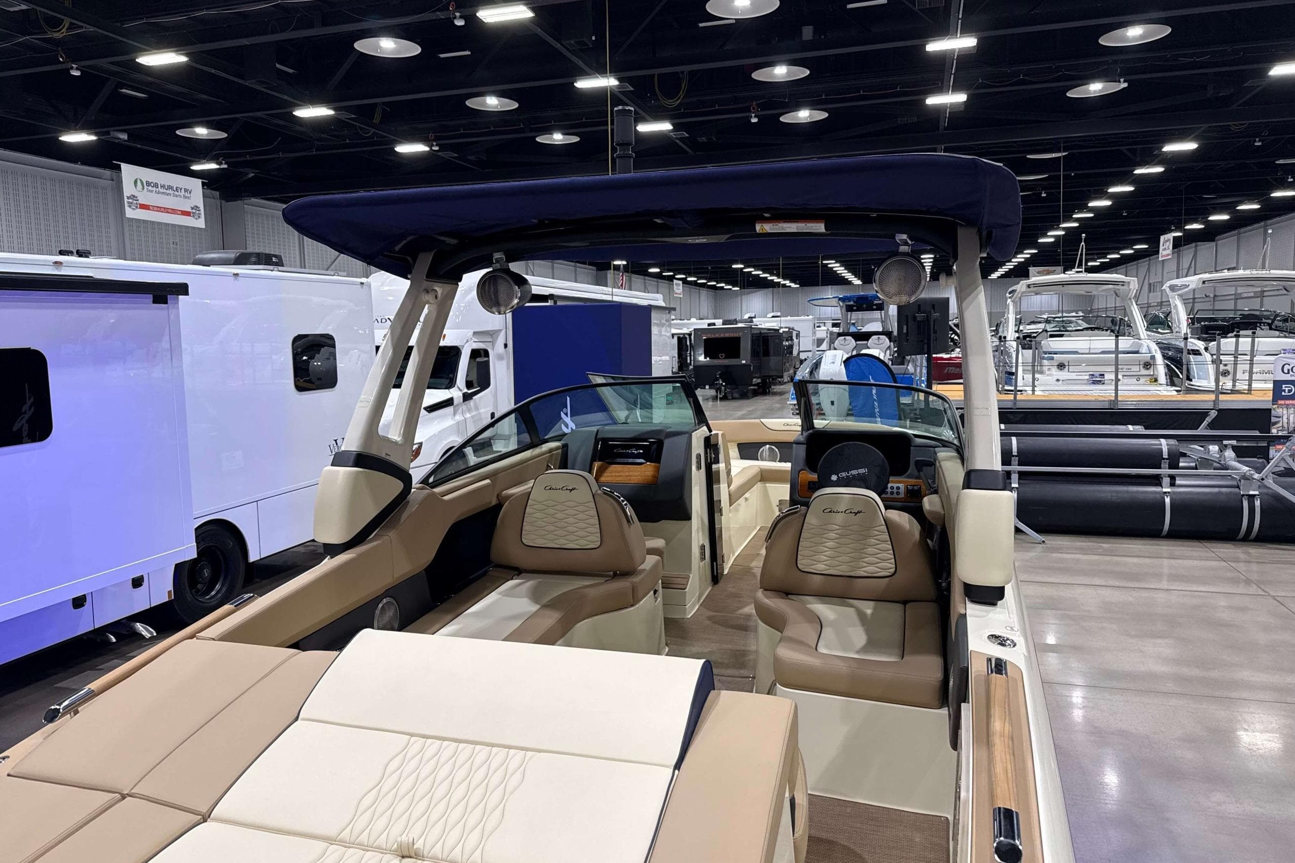 2026 Chris-Craft Sportster 28 boat interior at a showroom, featuring luxurious seating and modern design.