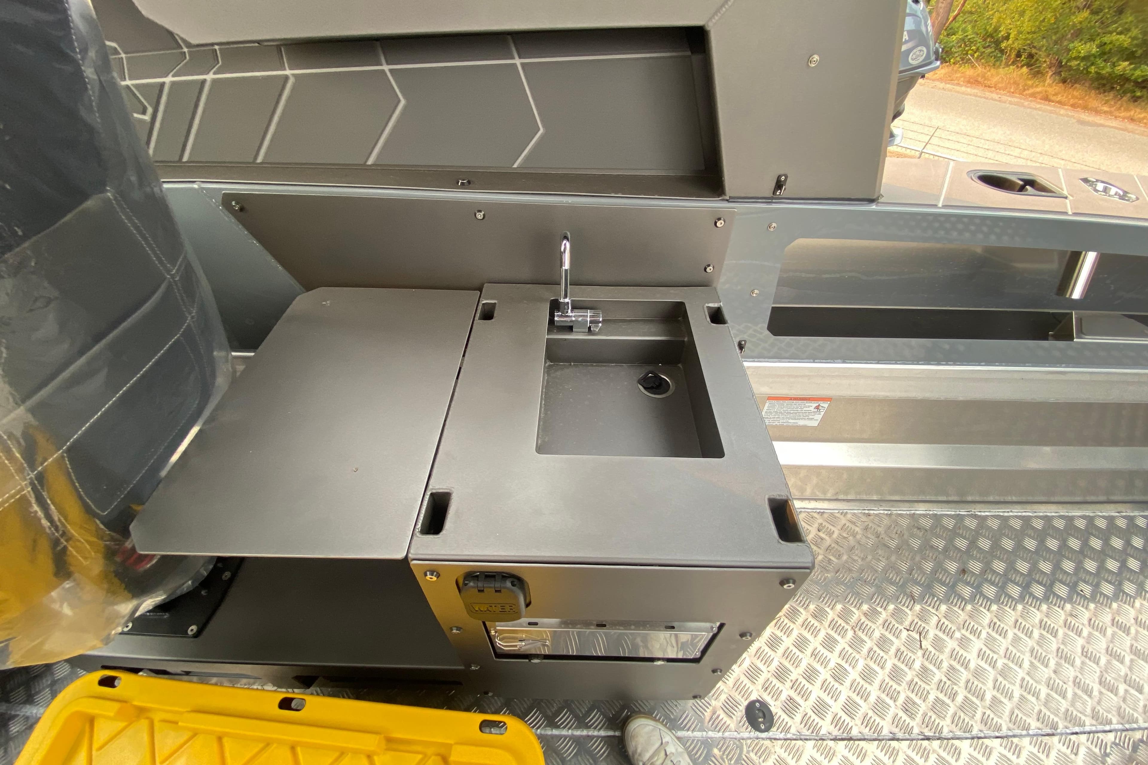 Interior of 2026 Stabicraft 2350 Supercab featuring a compact sink and storage area.