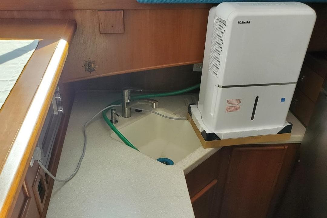 1988 Post 46 Sportfish boat kitchen with sink and dehumidifier.