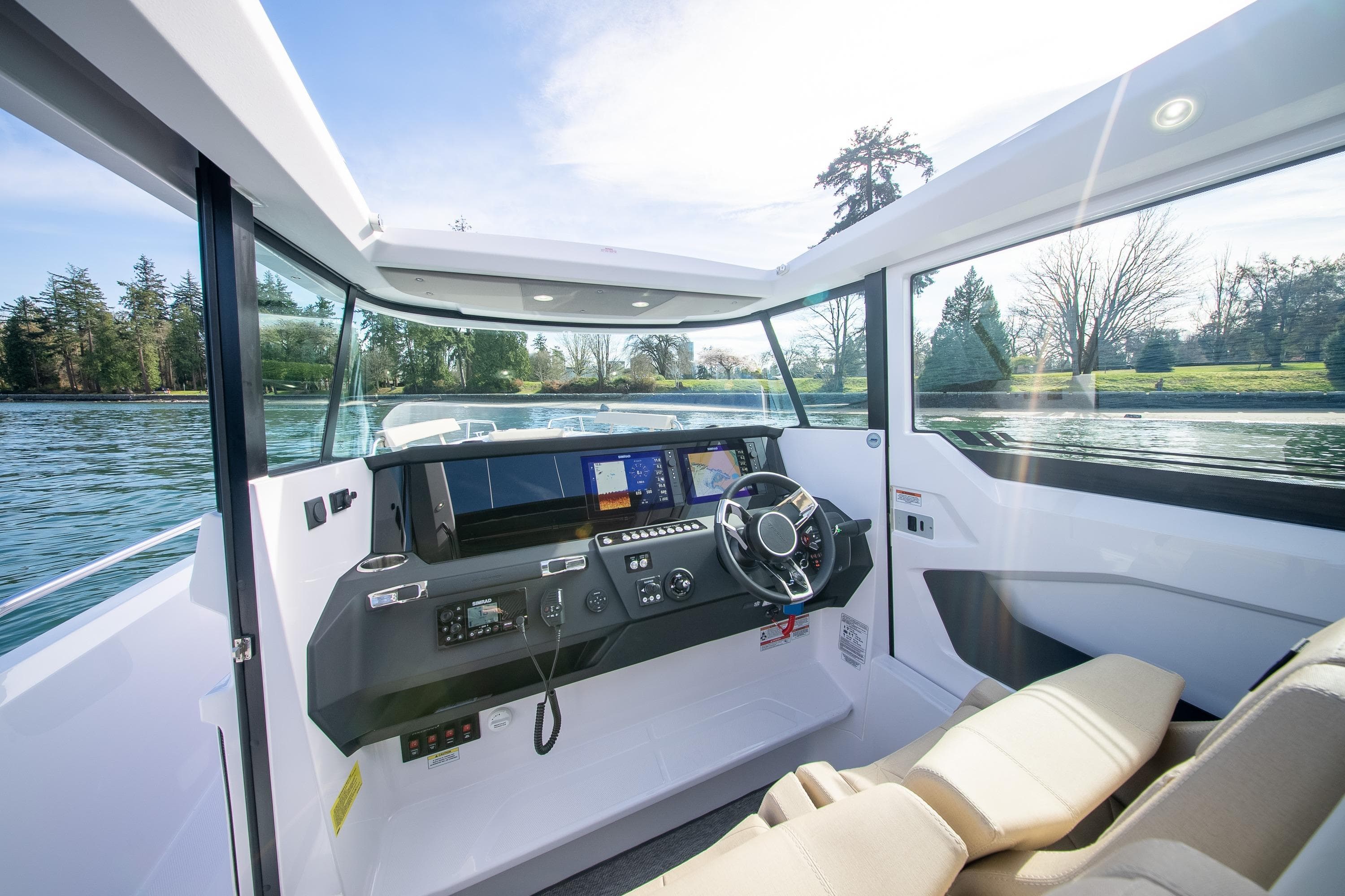 2026 Axopar 29 XC Cross Cabin interior with modern dashboard and scenic water view.