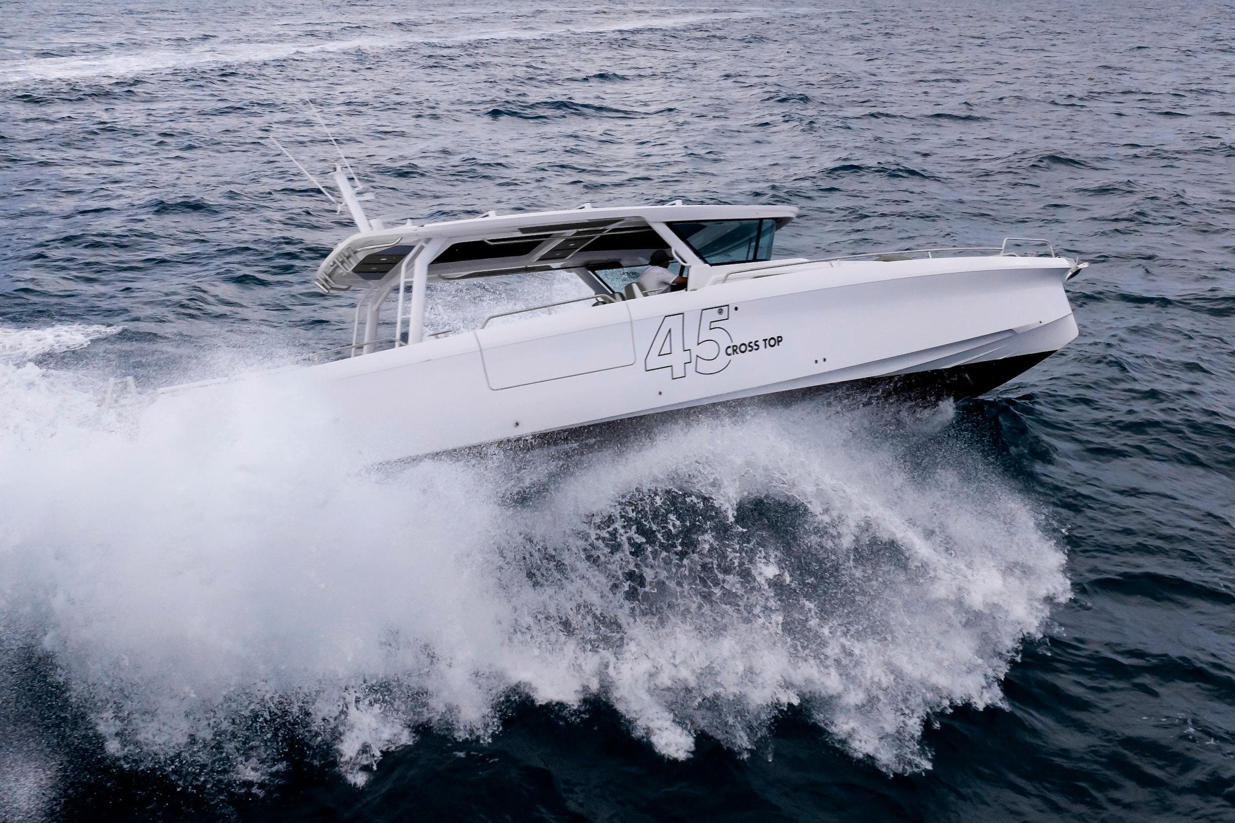 2025 Axopar 45 Cross Top boat navigating through ocean waves.