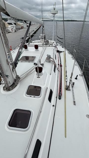 2003 J Boats J/46 sailboat deck with hatches, docked by the water.