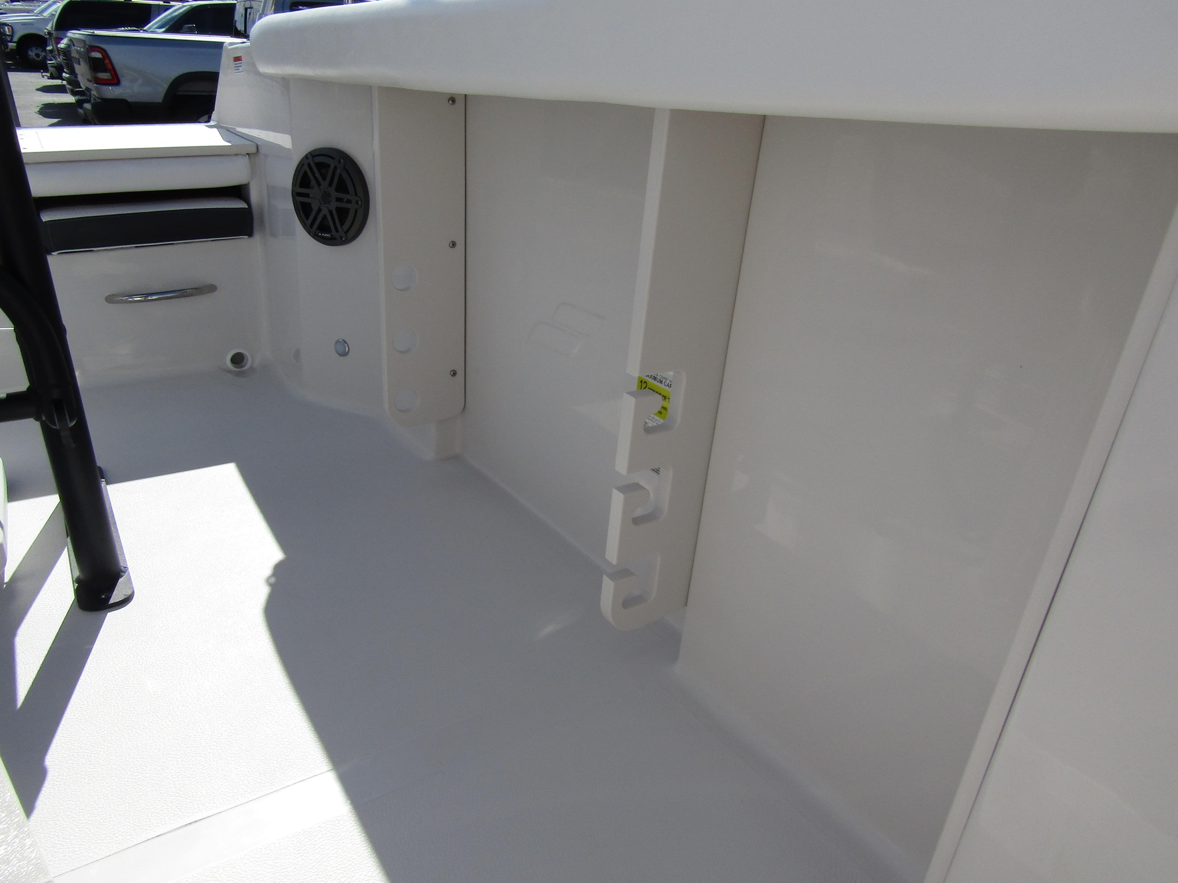 2024 Starcraft SVX 191 OB CC boat interior, featuring storage compartments and speaker.