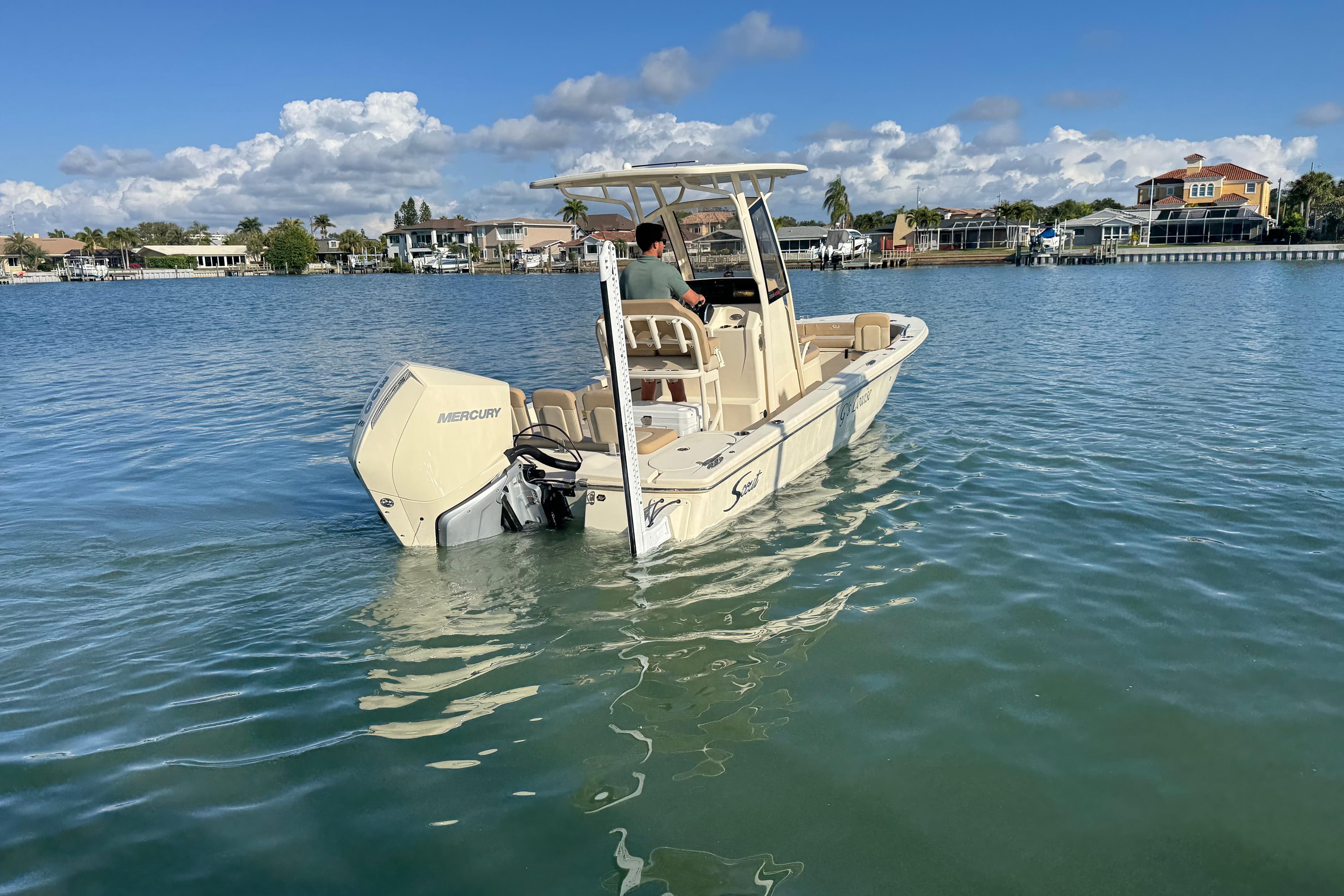 2024 Scout 231 XSB boat on calm water, featuring a Mercury engine.