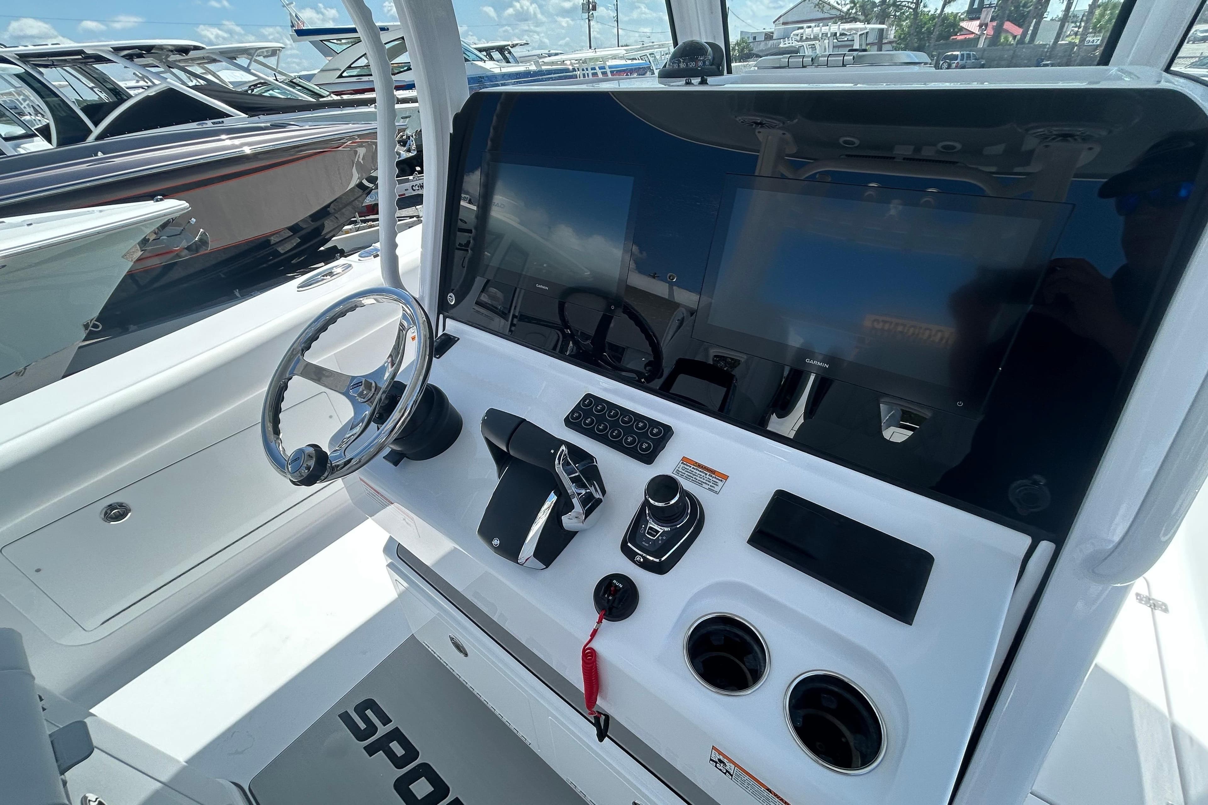 2026 Sportsman Heritage 321 Center Console boat dashboard with steering wheel and controls.