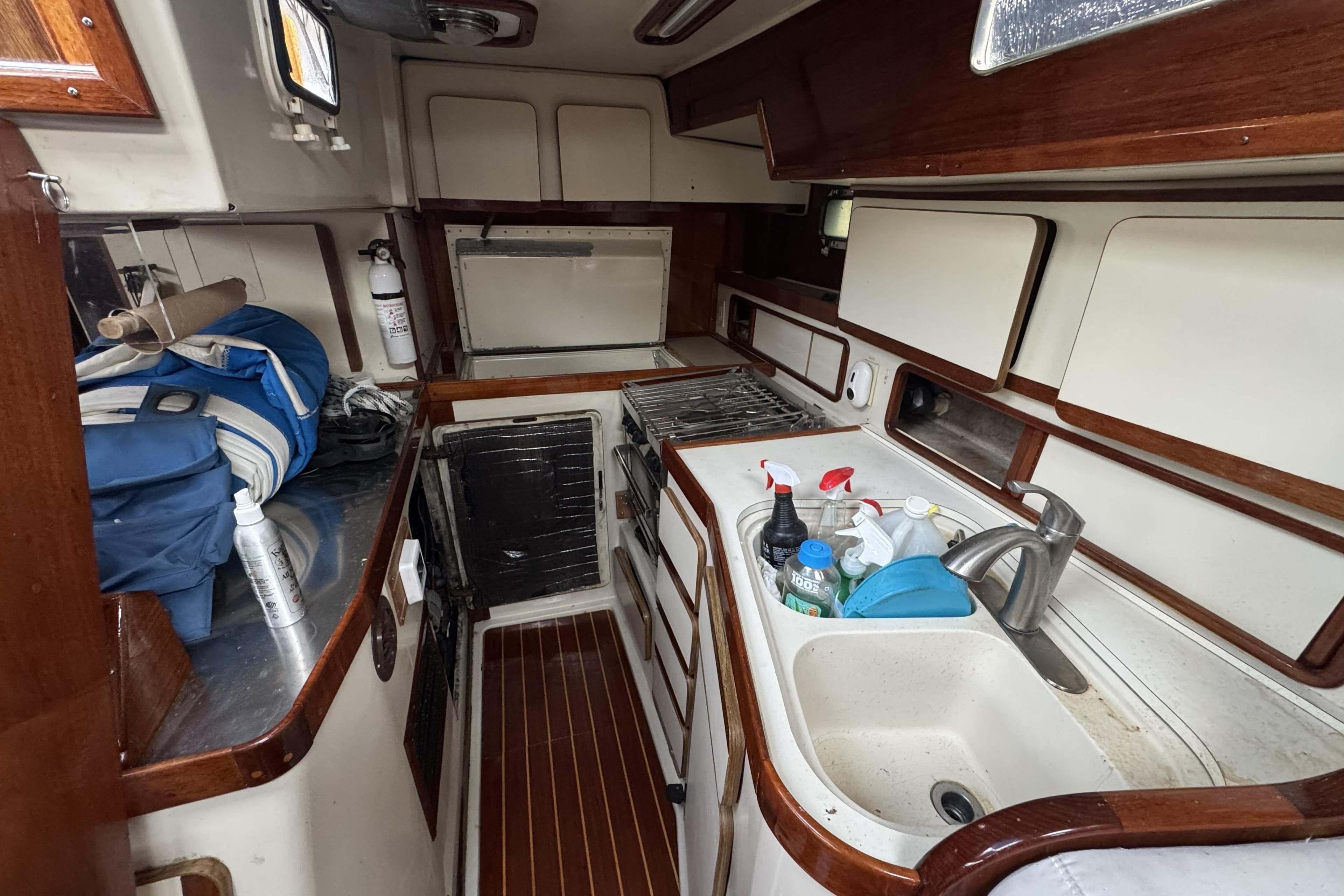 1987 Irwin 38 yacht kitchen with sink, stove, and storage cabinets.