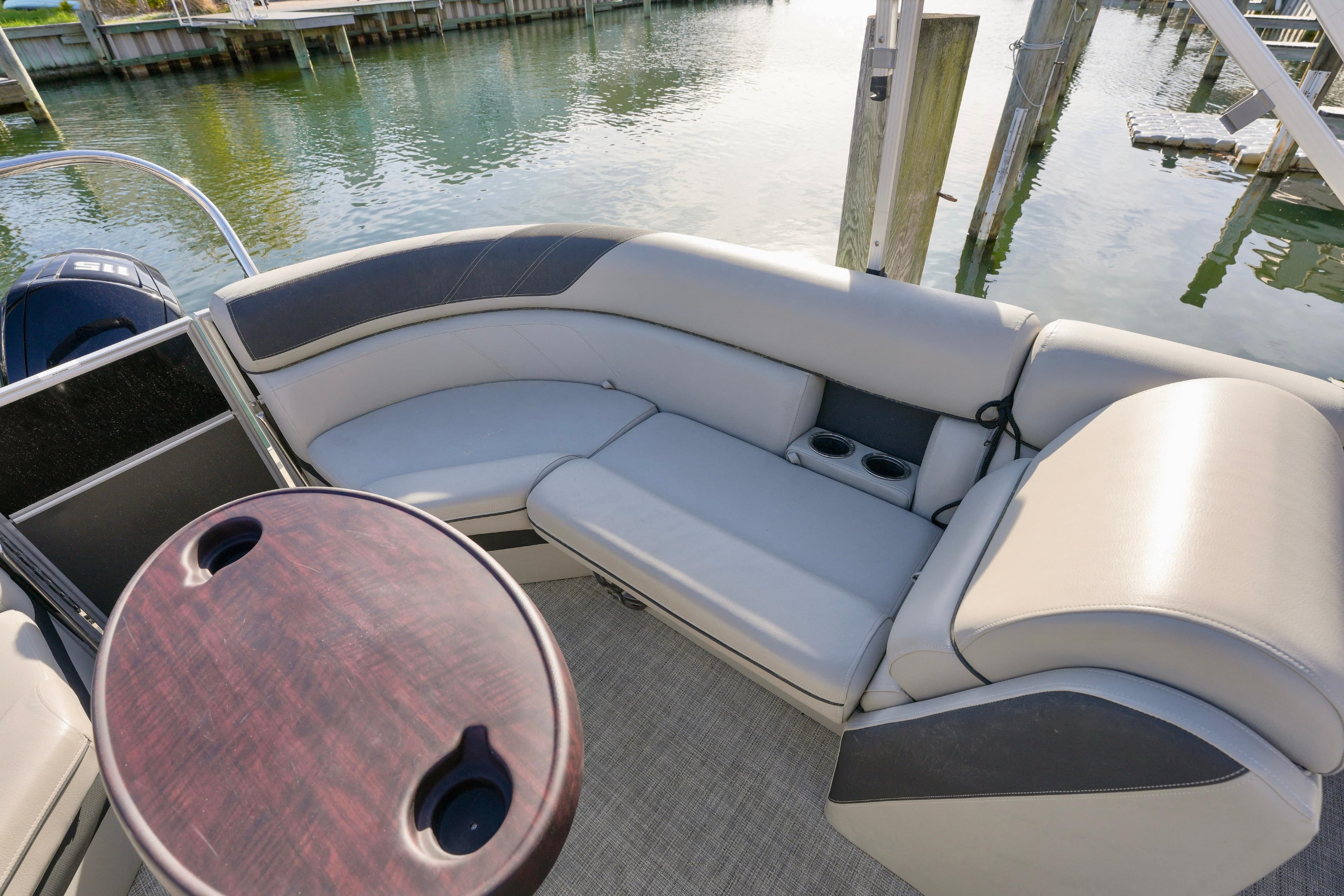 2023 Berkshire 24 RFX LE 2.75 pontoon boat interior with plush seating and table.