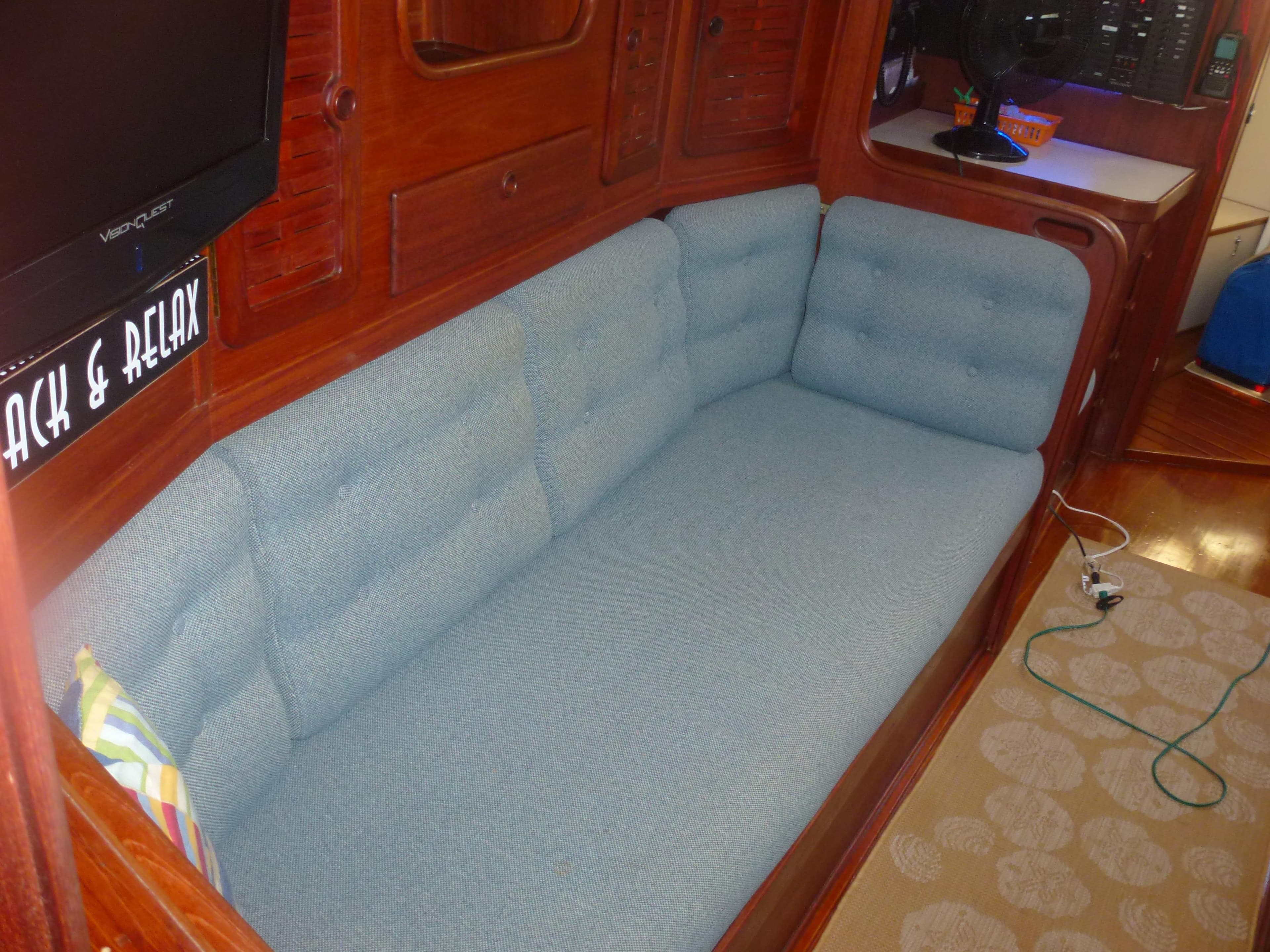 Interior of 1990 Sabre 425 sailboat with blue cushioned seating area.