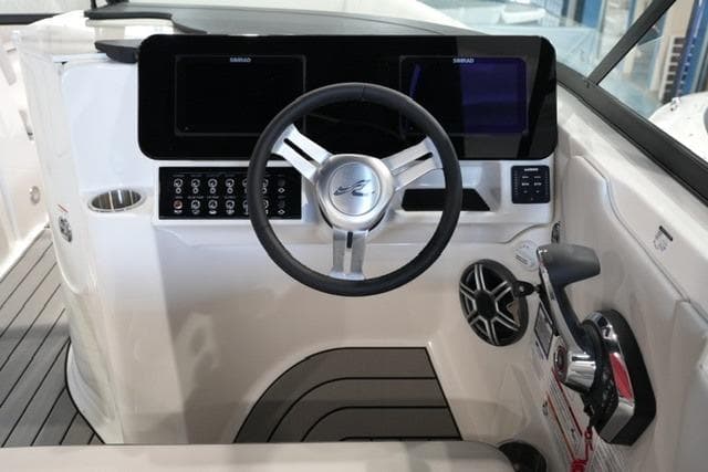 2026 Sea Ray SDX 270 helm with modern controls and sleek steering wheel design.
