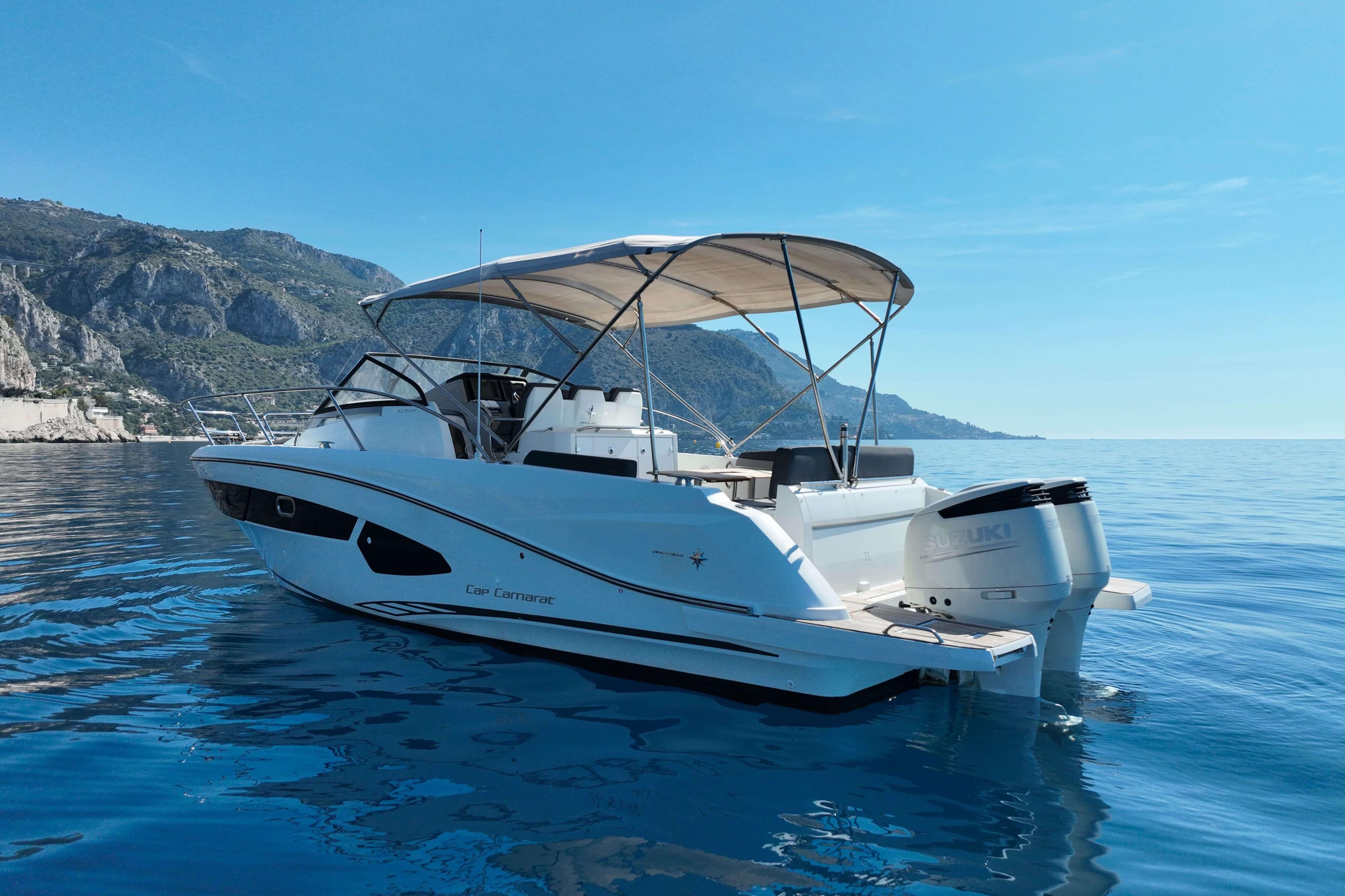 2018 Cap Camarat 10.5 WA boat on calm blue water with scenic mountain backdrop.