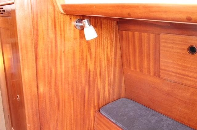 Wooden interior of a 1973 Ohlson 38 sailboat with a small light fixture.