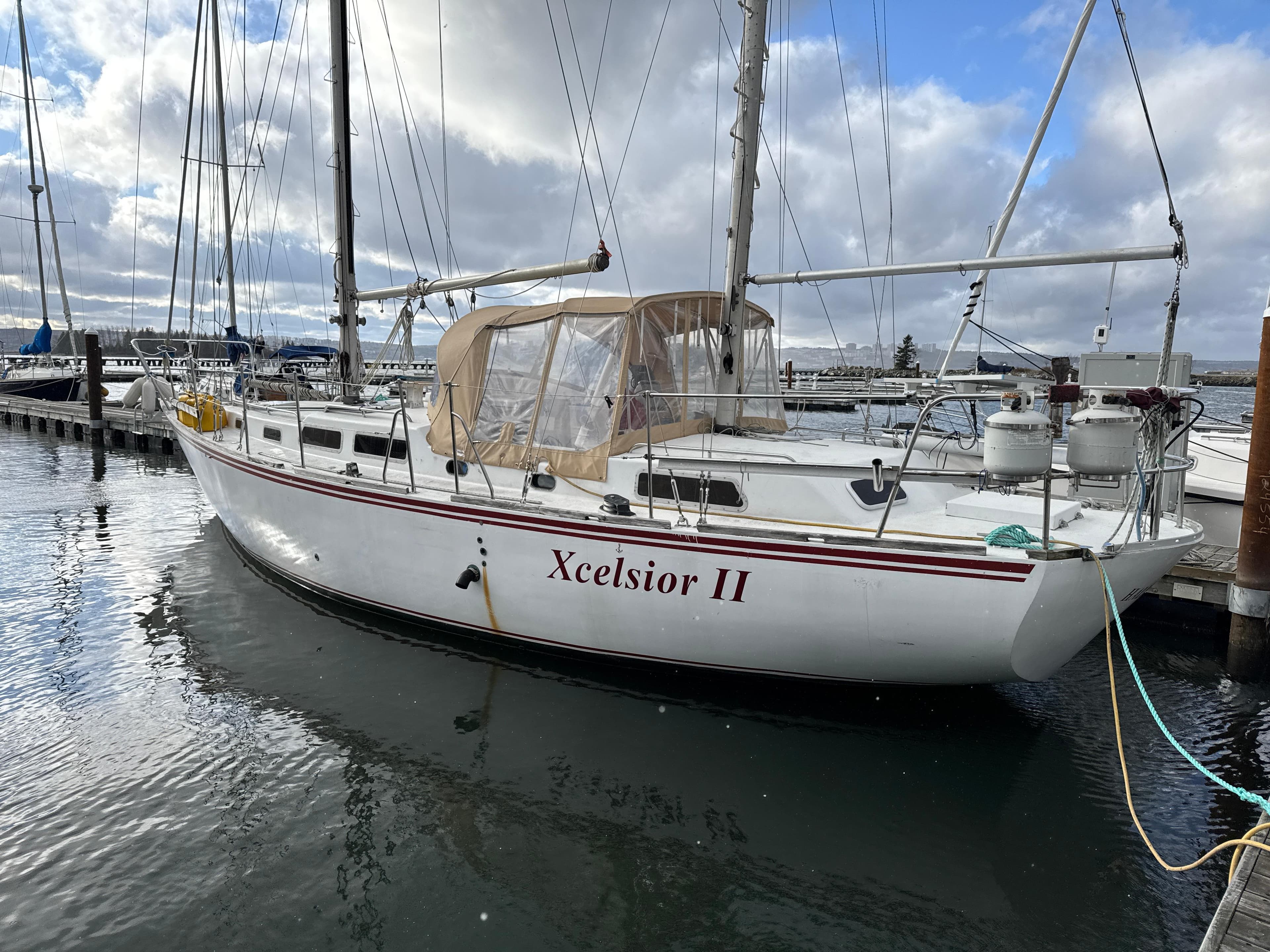 Bruce Roberts Mauritius 43 sailboat, 1980 model, named Xcelsior II, docked at a marina.
