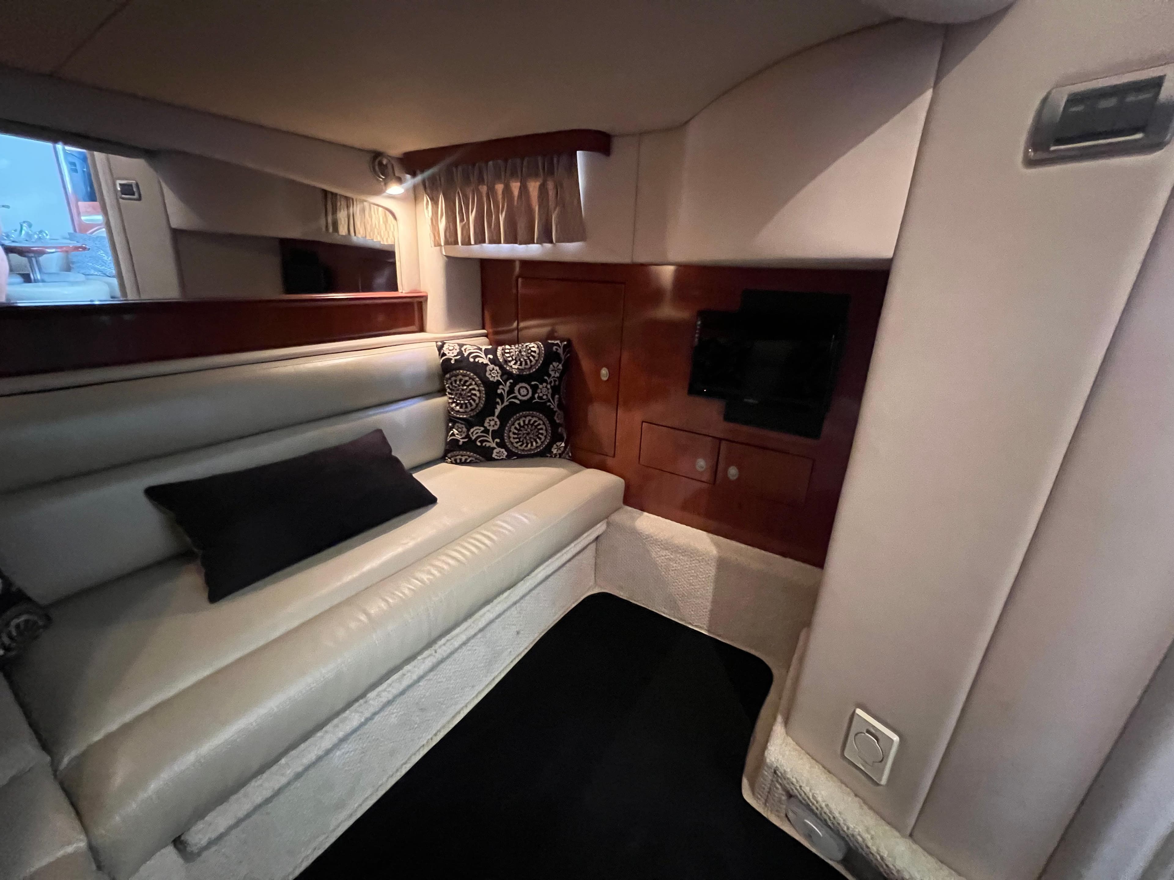 Luxurious interior of 2005 Sea Ray 420 Sundancer yacht with plush seating and TV.