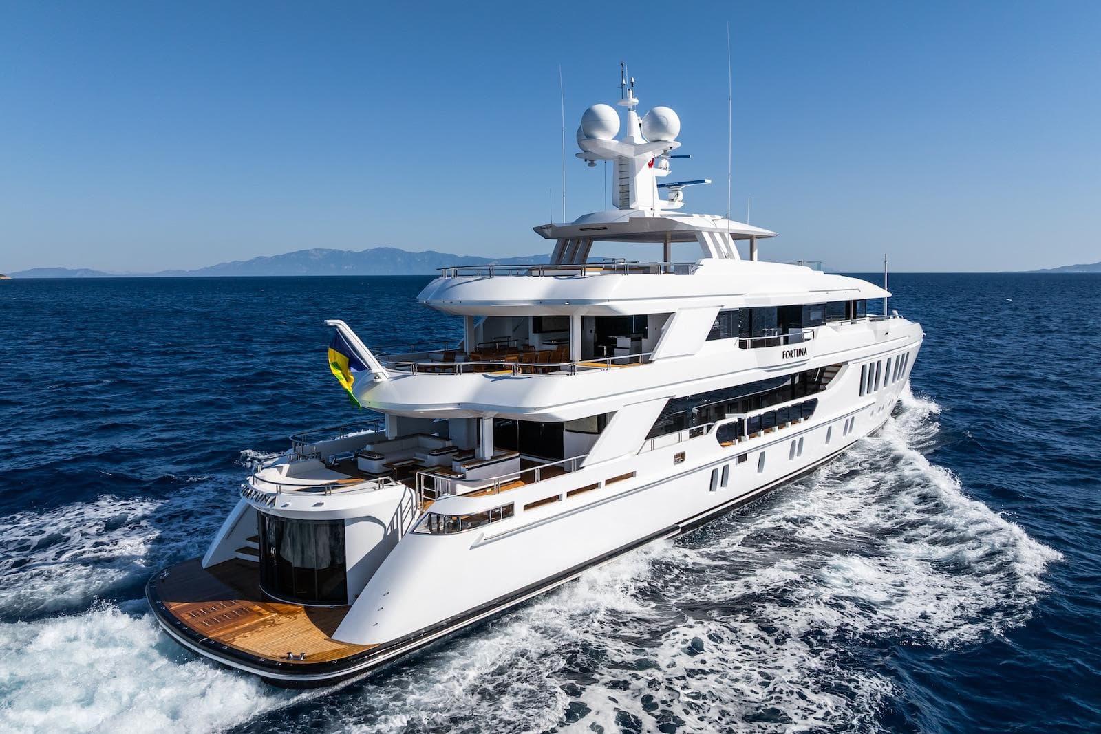 Luxurious 2022 CMB Yachts CMB 47 cruising on open sea under clear blue sky.