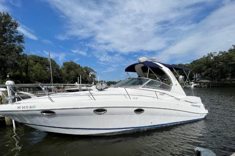 2006 Four Winns 318 Vista boat docked on a sunny day with blue sky.