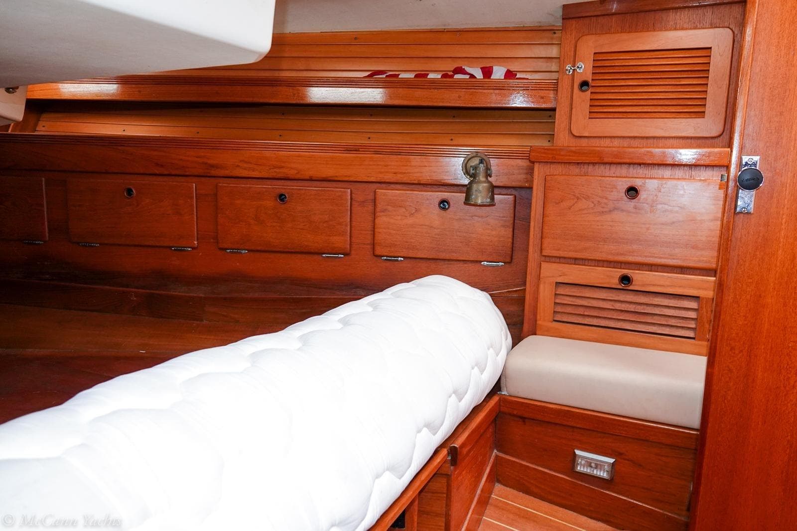 Interior of 1987 Sabre 42 yacht with wooden cabinetry and cushioned seating.