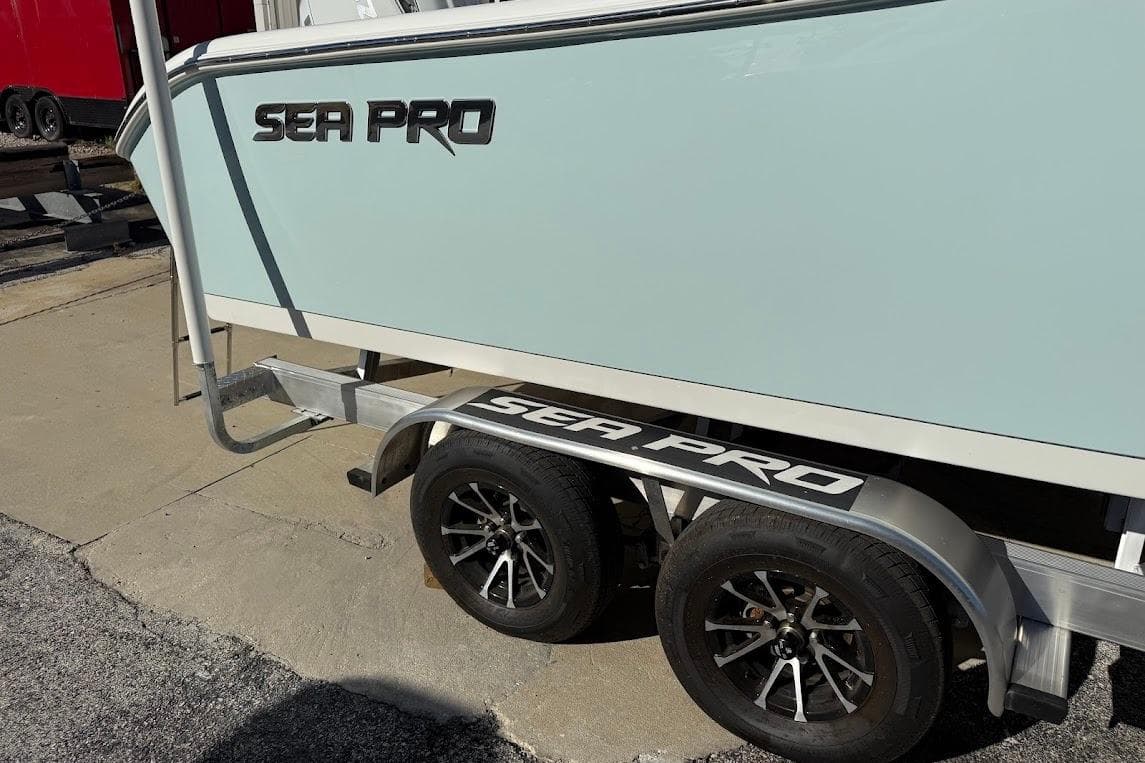 2026 Sea Pro 240 Dual Console boat on trailer, showcasing sleek design and branding.