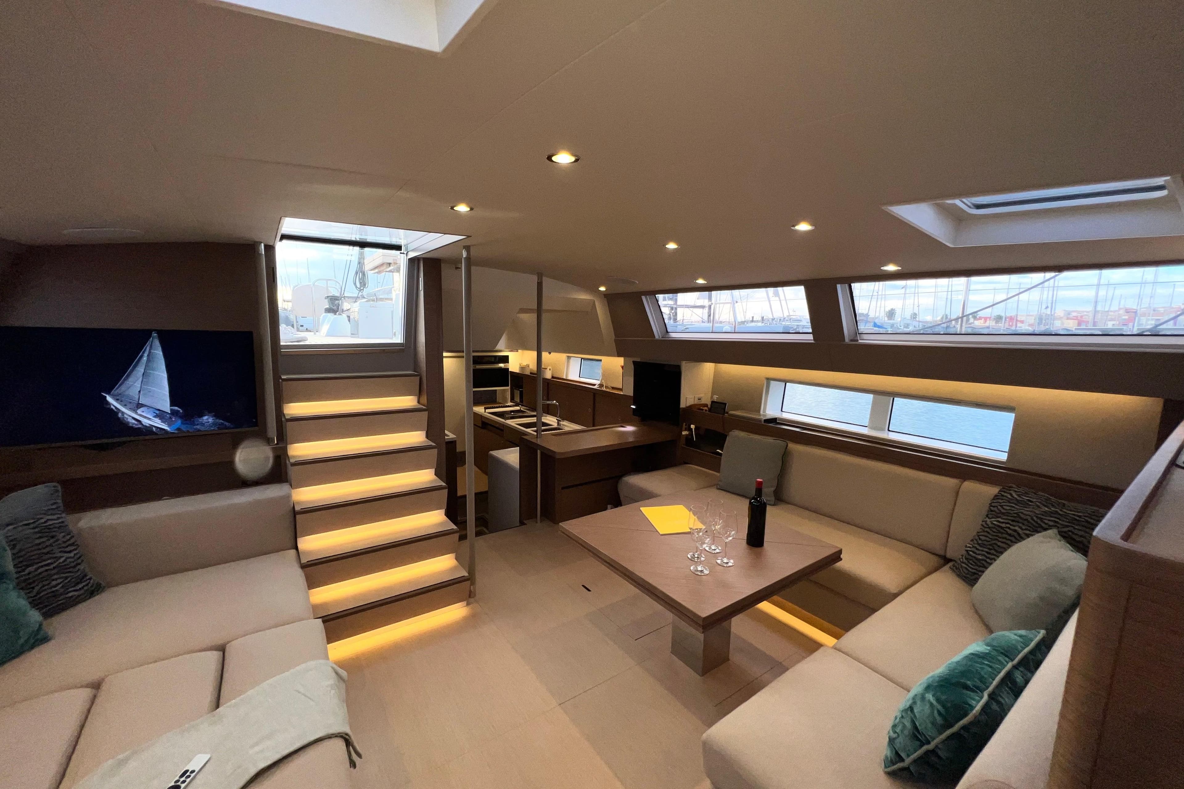 Luxurious interior of 2021 CNB 66 yacht with modern seating and elegant lighting.