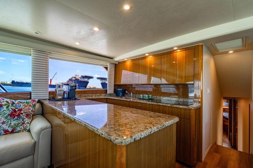Luxurious interior of 2006 Viking 56 Convertible yacht with granite countertops and ocean view.