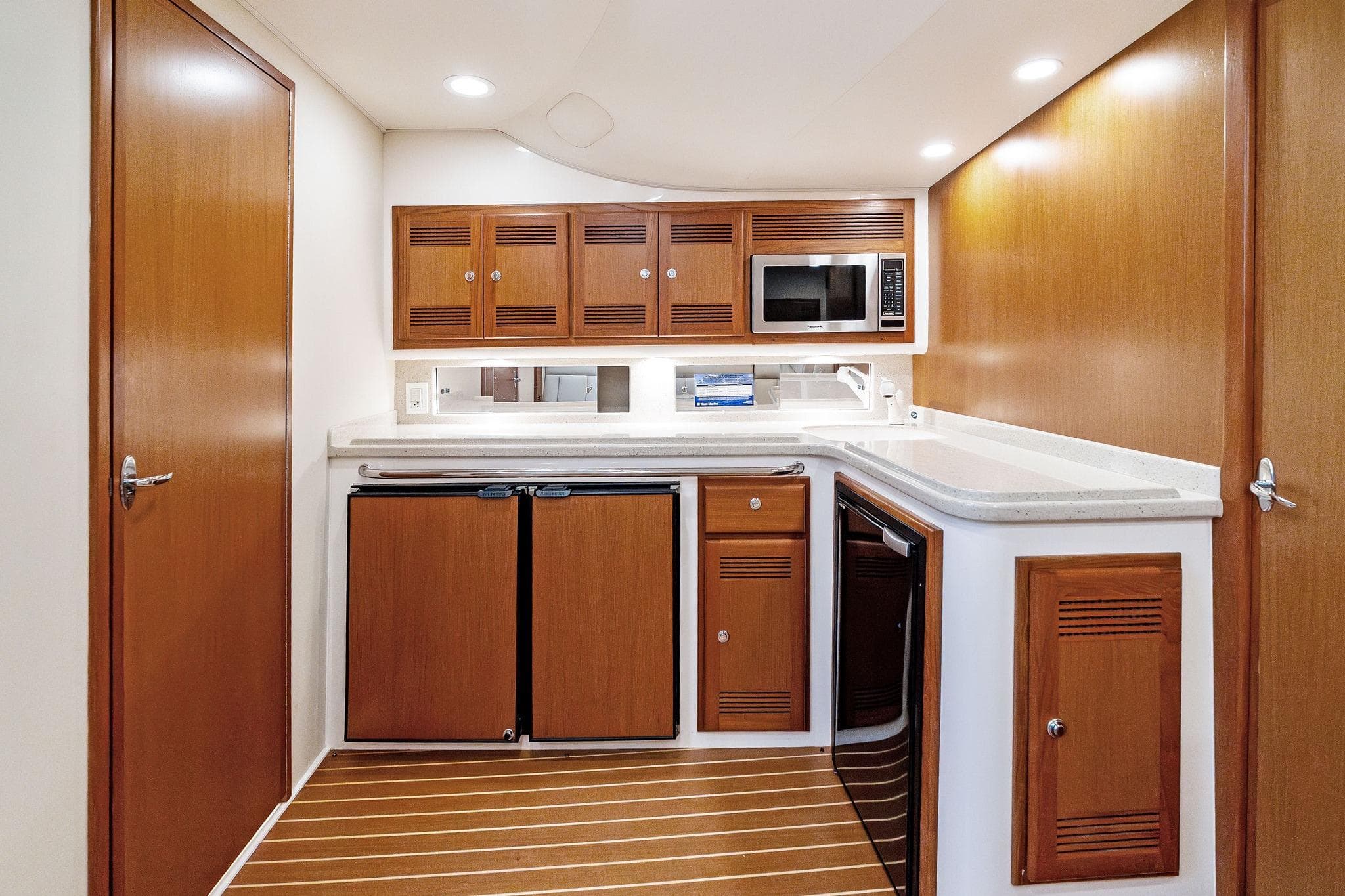 2004 Cabo 40 Hardtop Express yacht interior kitchen with wood cabinetry and modern appliances.