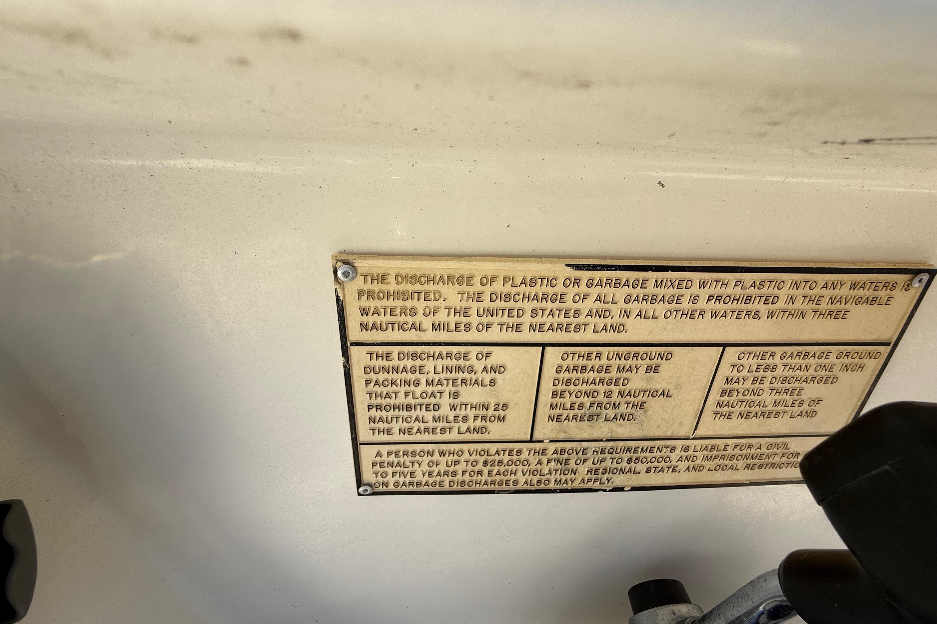 Warning plaque on 2000 Sport-Craft 241 Walk Around boat about garbage discharge regulations.
