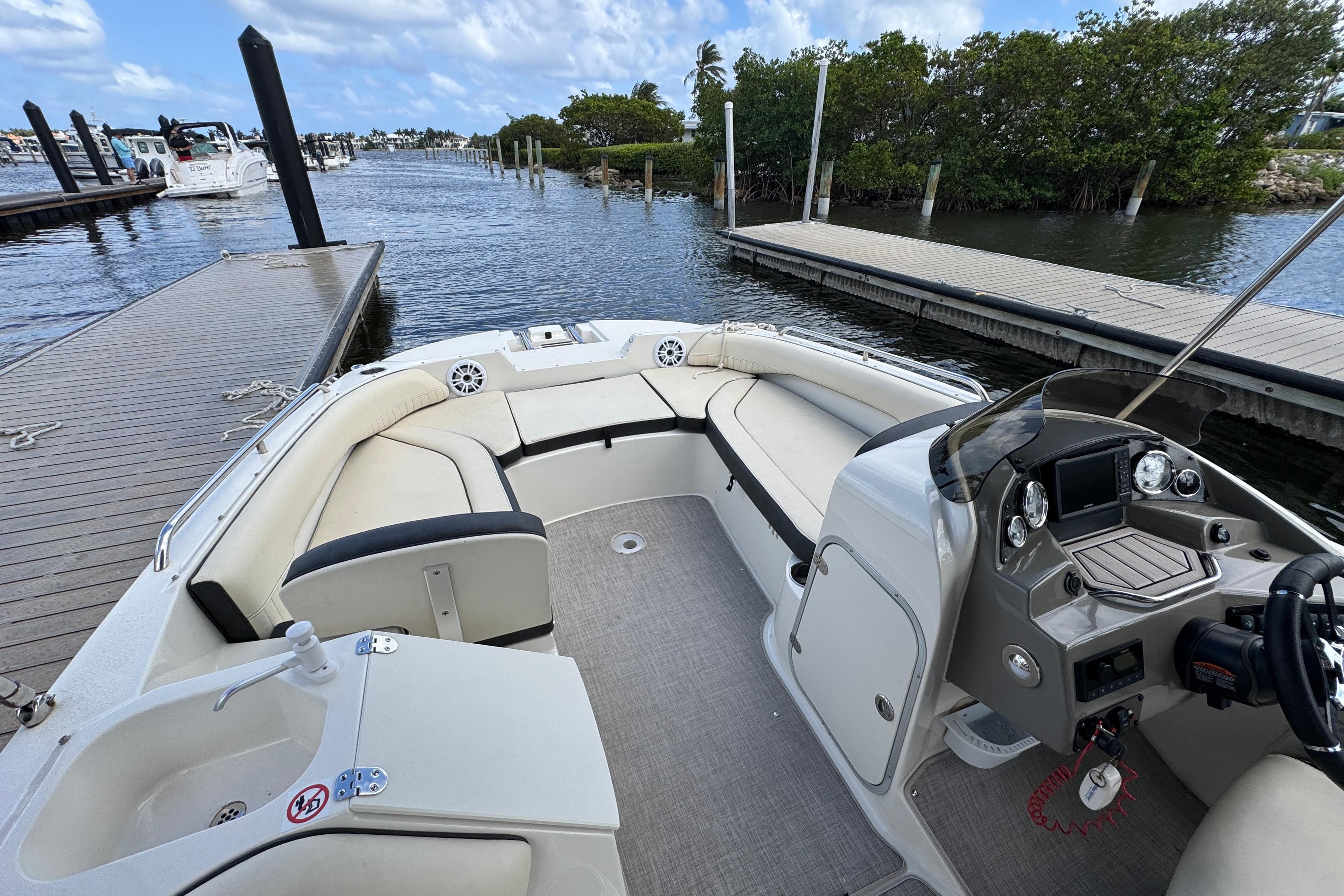 2022 Stingray 192 SC boat interior with seating and helm, docked by a marina.