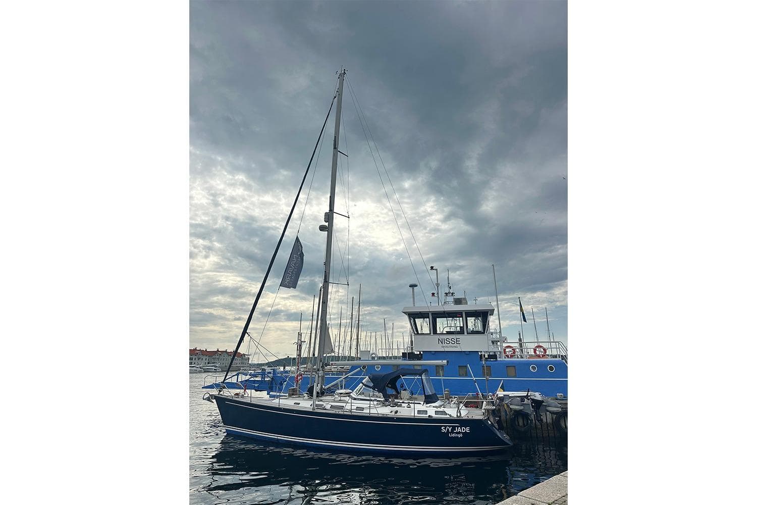 Sailing yacht Najad 460, 2004 model, docked under cloudy skies.