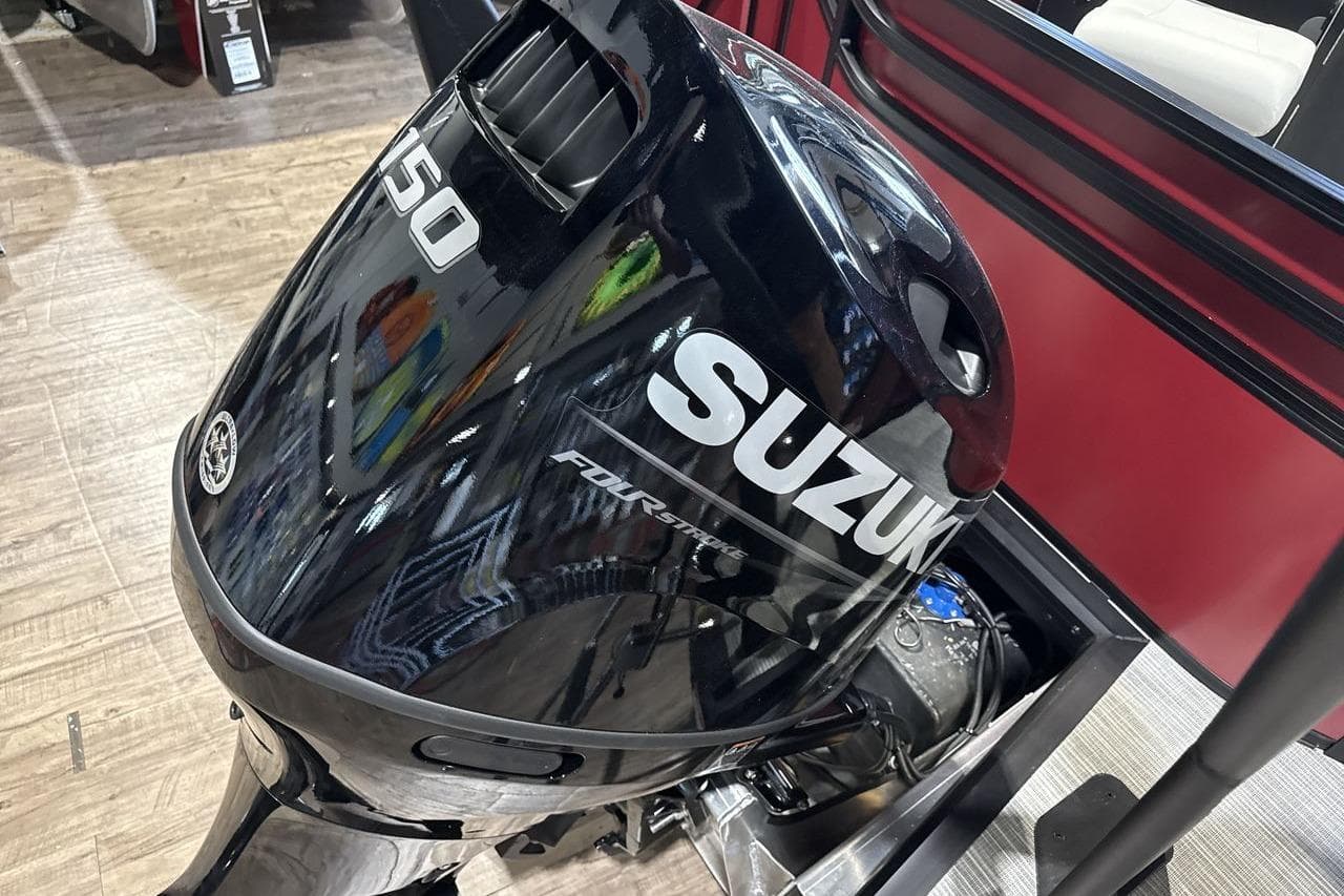 Suzuki 150 horsepower outboard motor on Viaggio V20R 2026 boat, displayed indoors.
