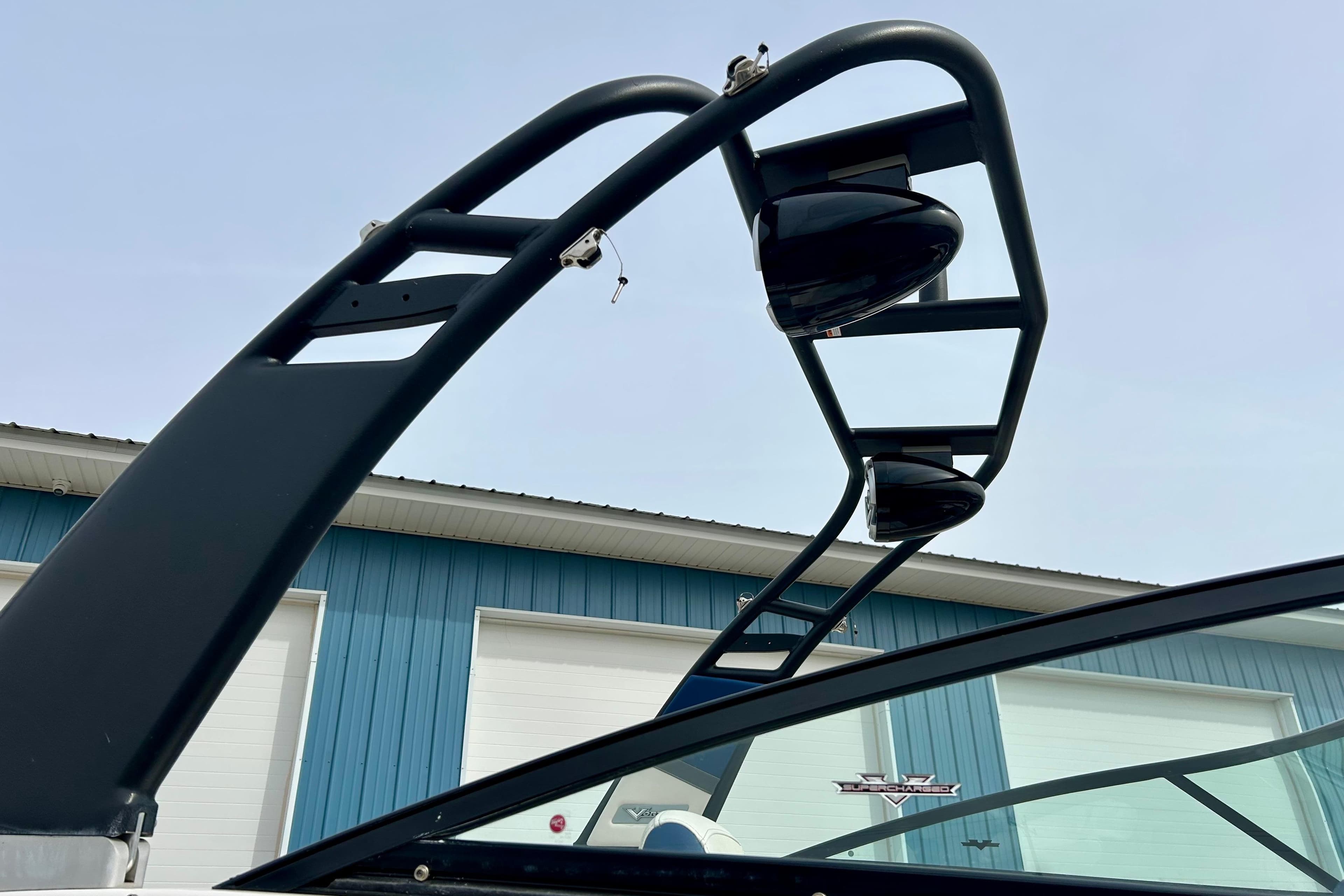 2017 Chaparral 203 Vortex boat tower against blue sky and building background.