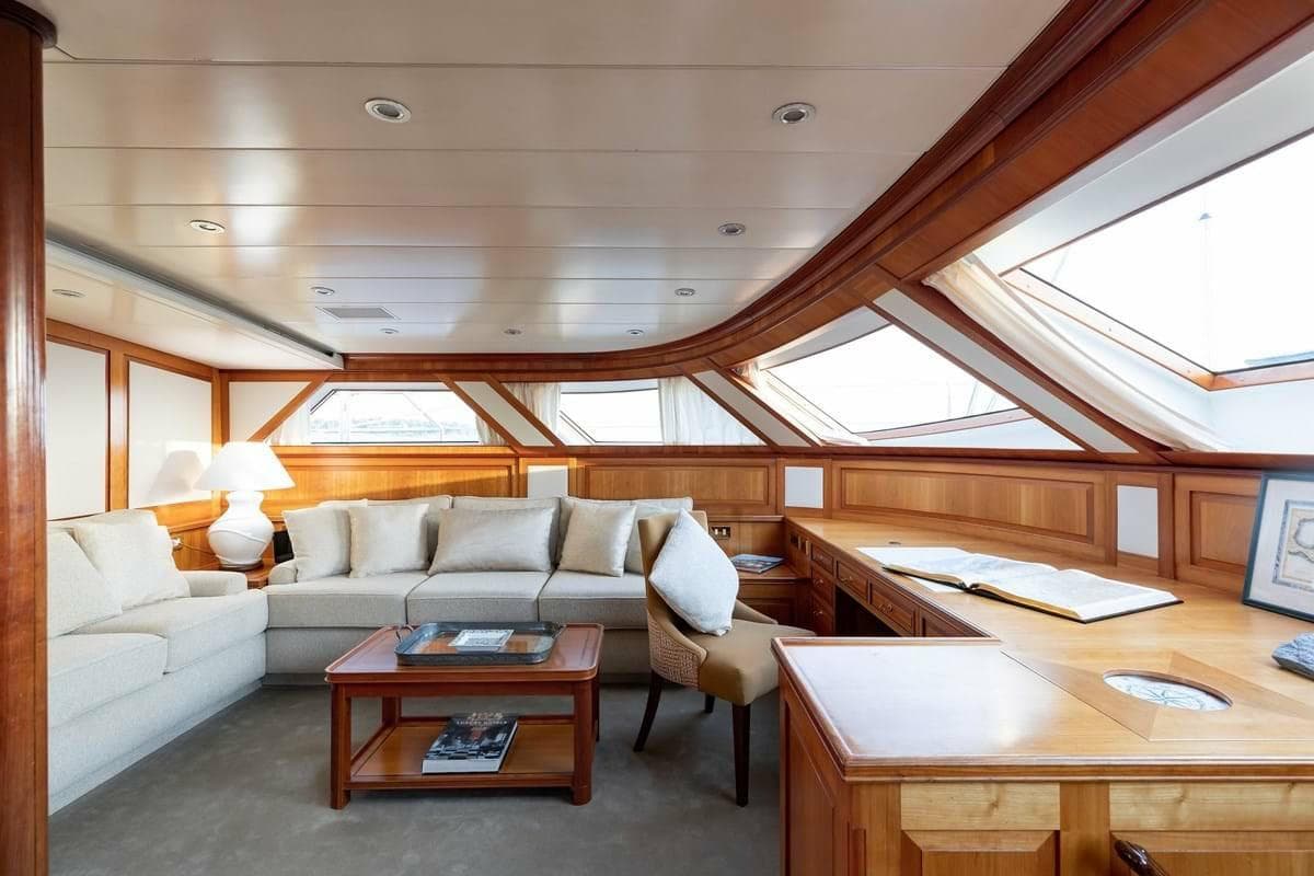 Luxurious interior of 1996 Perini Navi Ketch yacht with elegant wood and plush seating.
