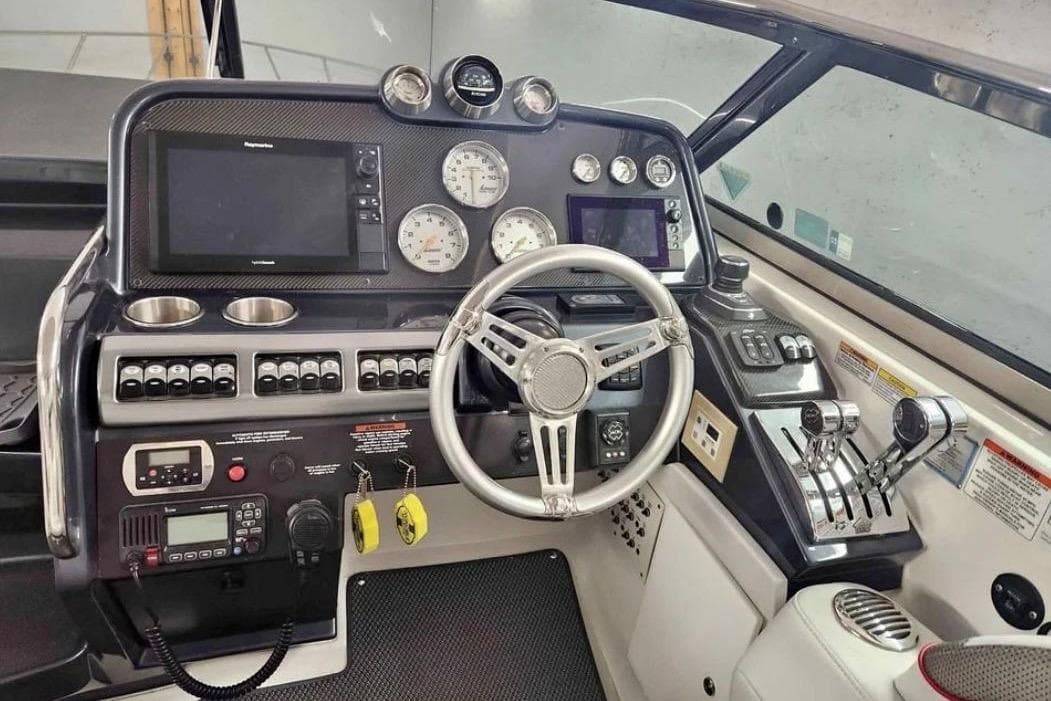 Control panel of a 2017 Formula 370 Super Sport boat with steering wheel and gauges.