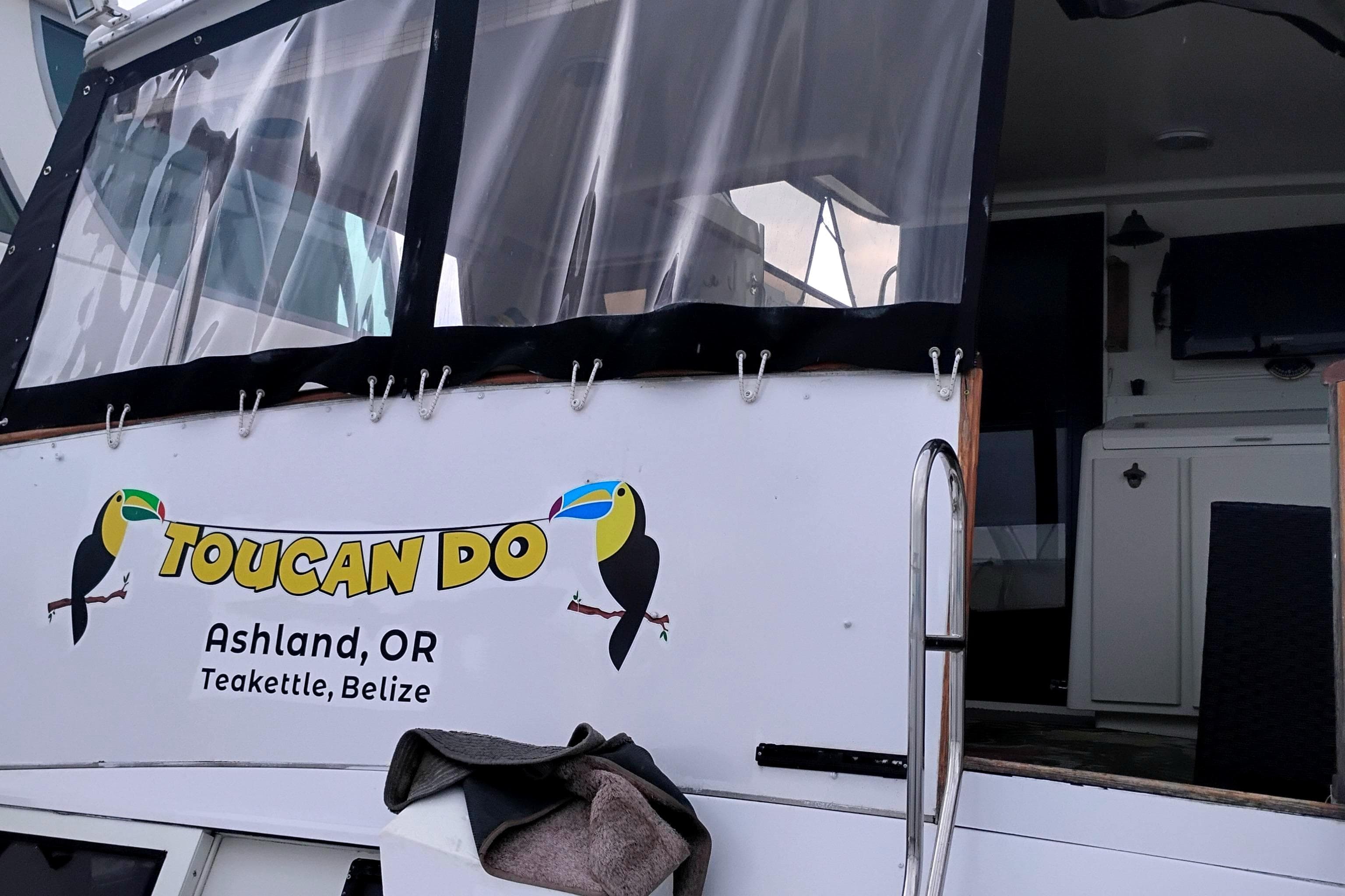 1991 Californian 52 Cockpit Motor Yacht with "Toucan Do" signage, Ashland, OR, Teakettle, Belize.