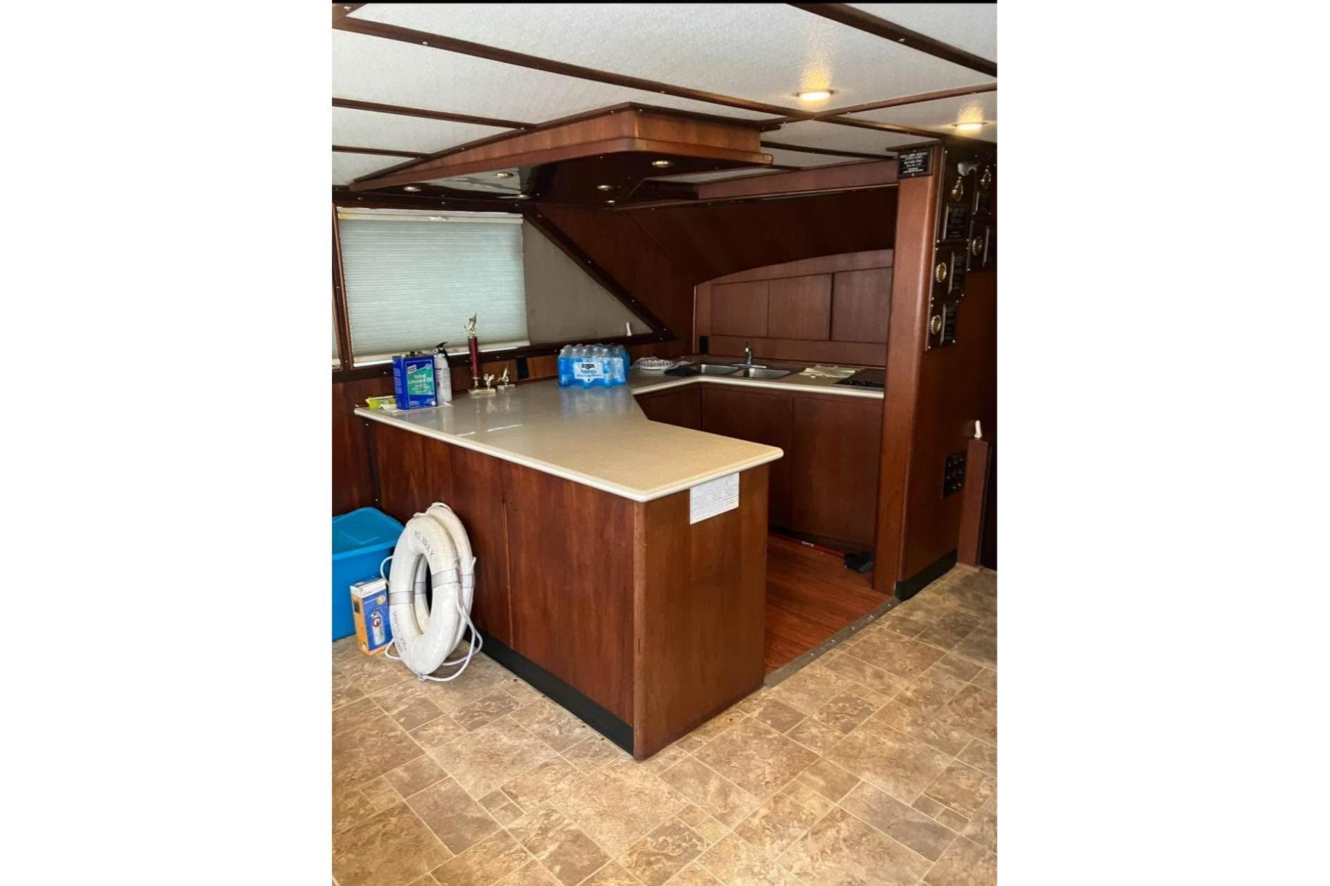 Interior of 1994 Breaux Bay Craft 58 Sportfish with wooden cabinetry and kitchen area.