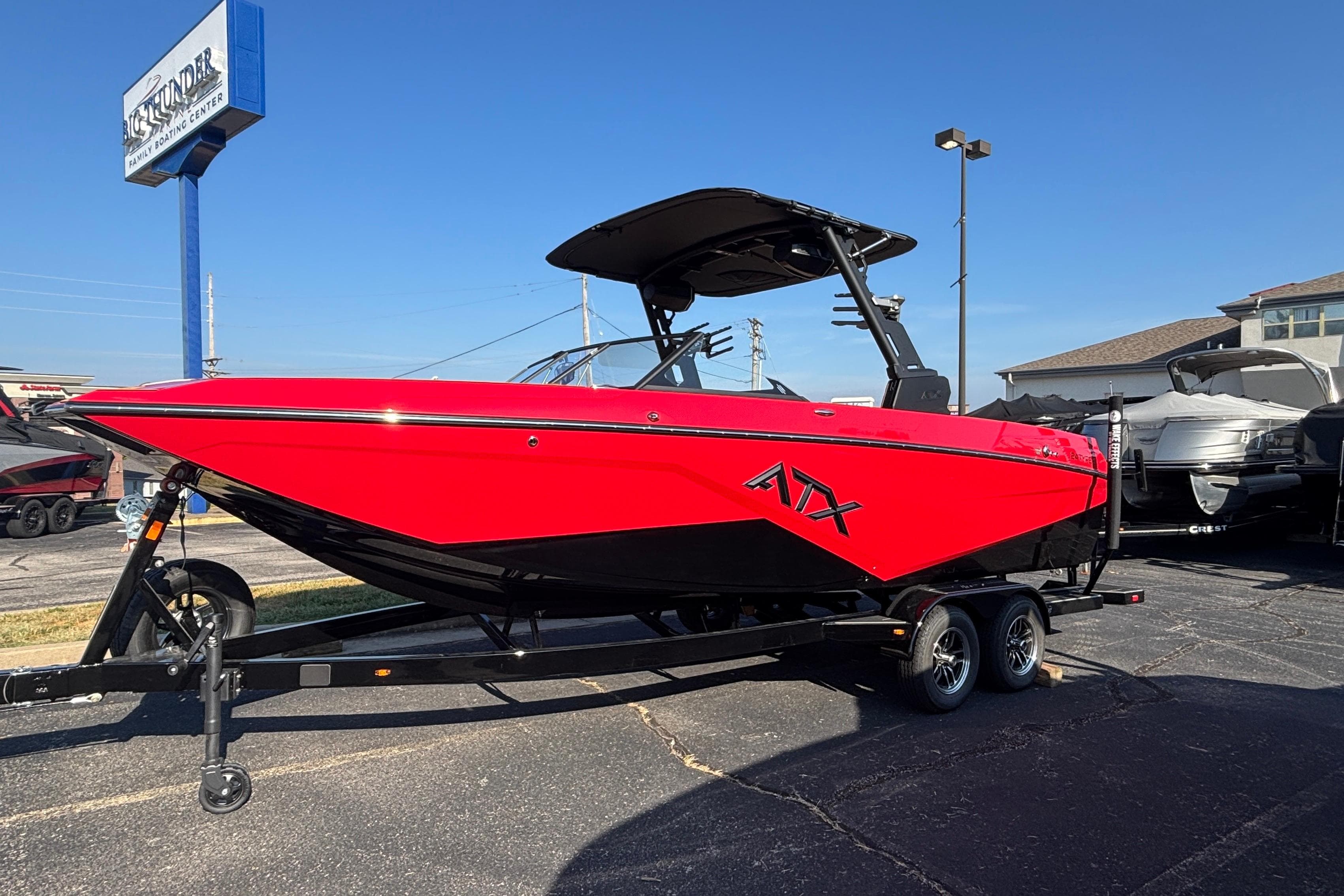 Red 2026 ATX Surf Boats 24 Type-S on trailer at dealership.