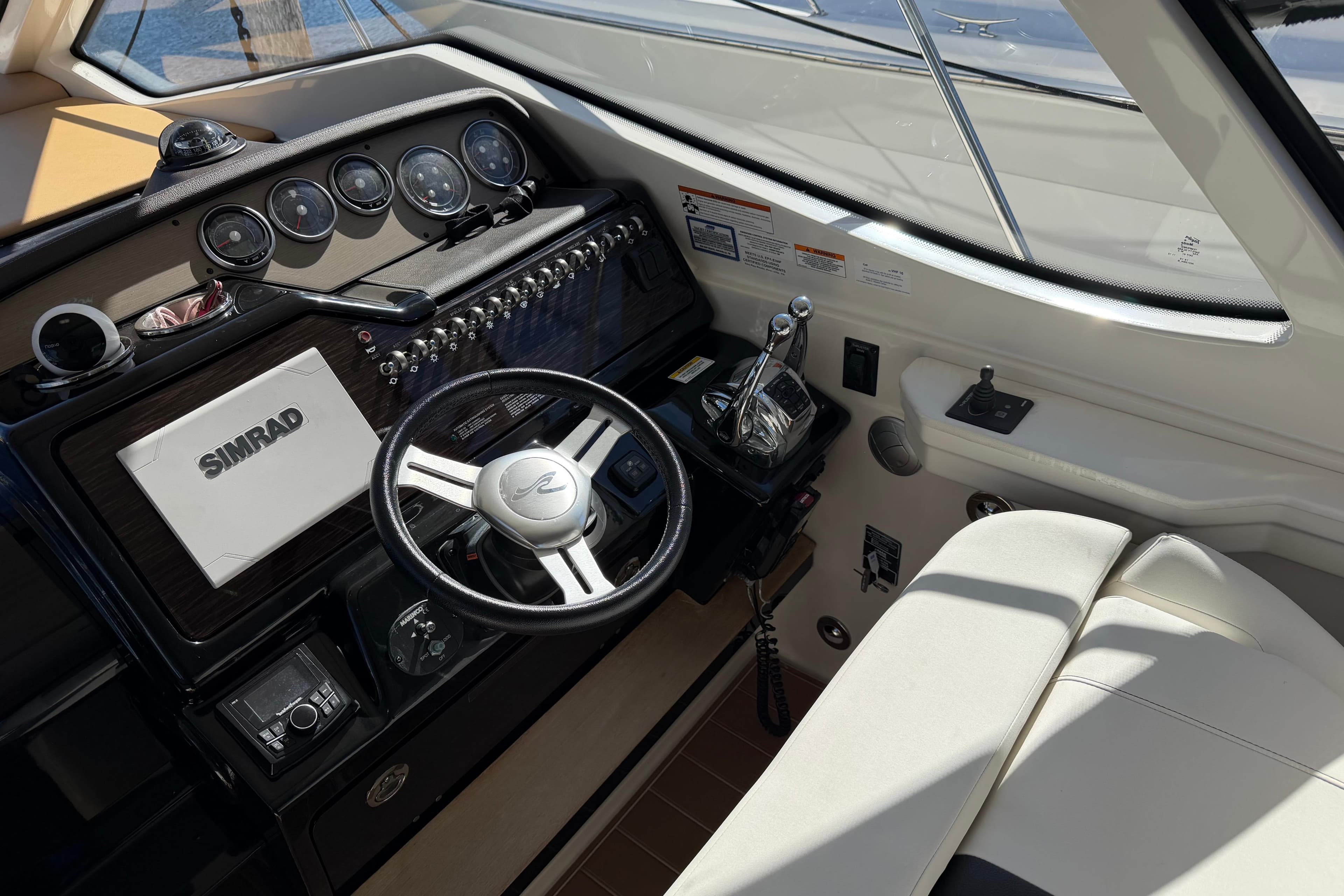 2018 Sea Ray 350 Sundancer helm with Simrad navigation system and luxurious seating.