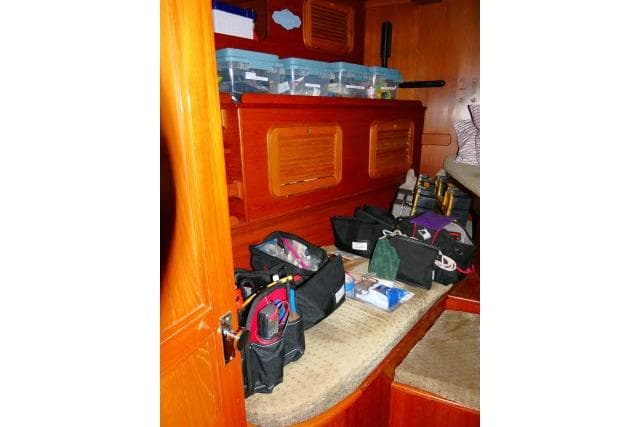 Interior of 1982 Ta Shing Mason 63 yacht with organized storage and wooden cabinetry.