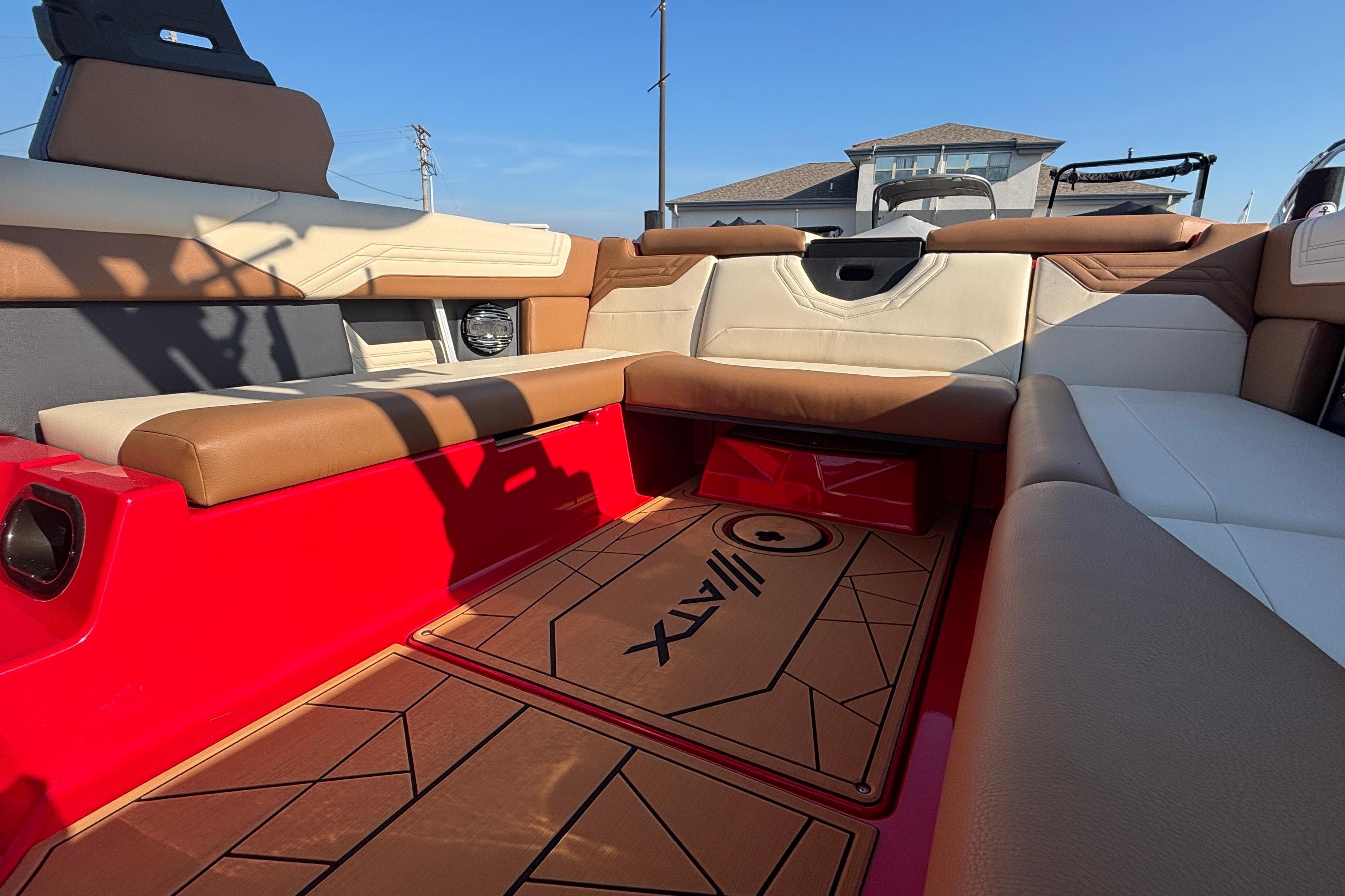 Interior of 2026 ATX Surf Boats 24 Type-S with red and tan seating.