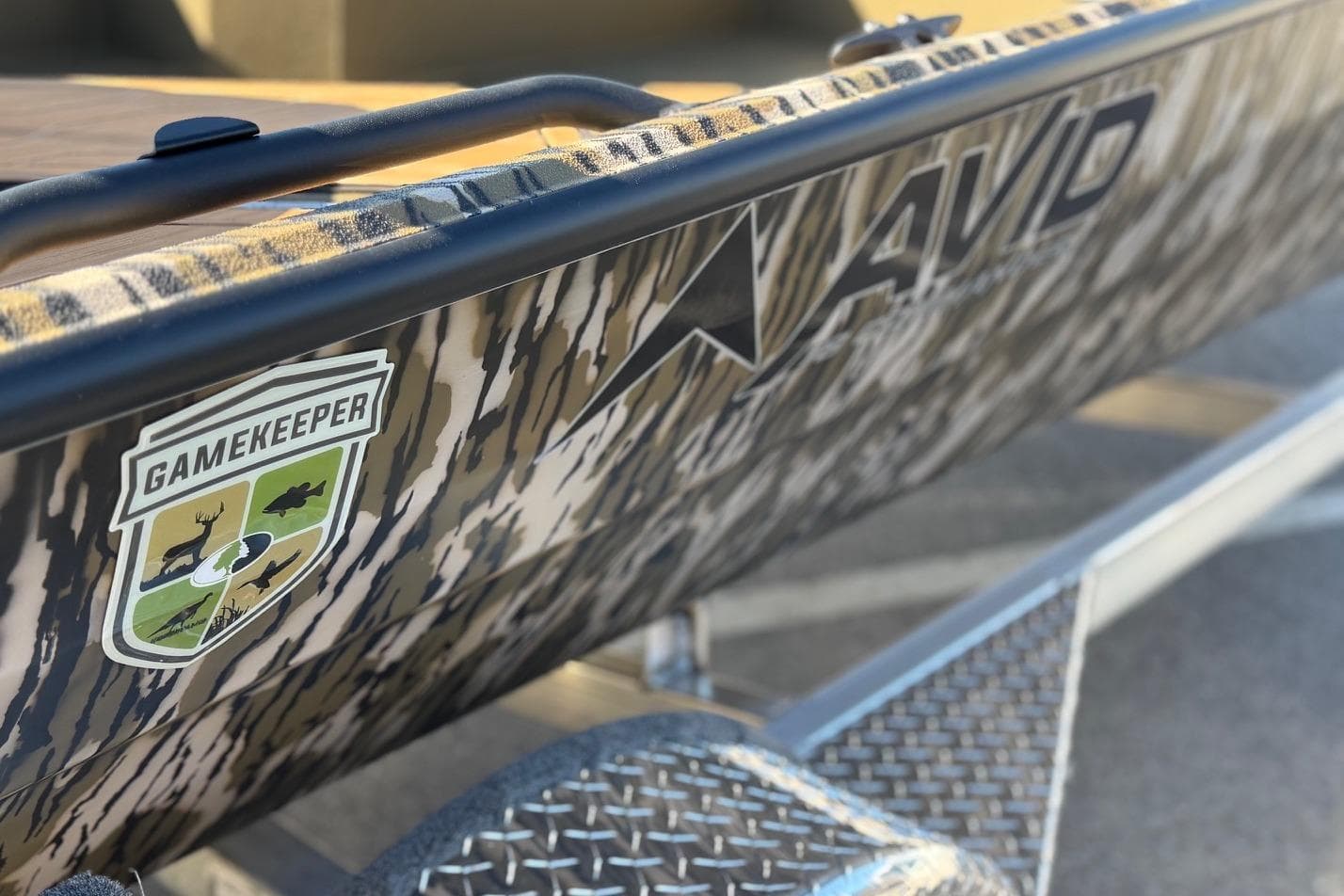 2026 Avid 18 Commander boat with camo design and Gamekeeper logo.