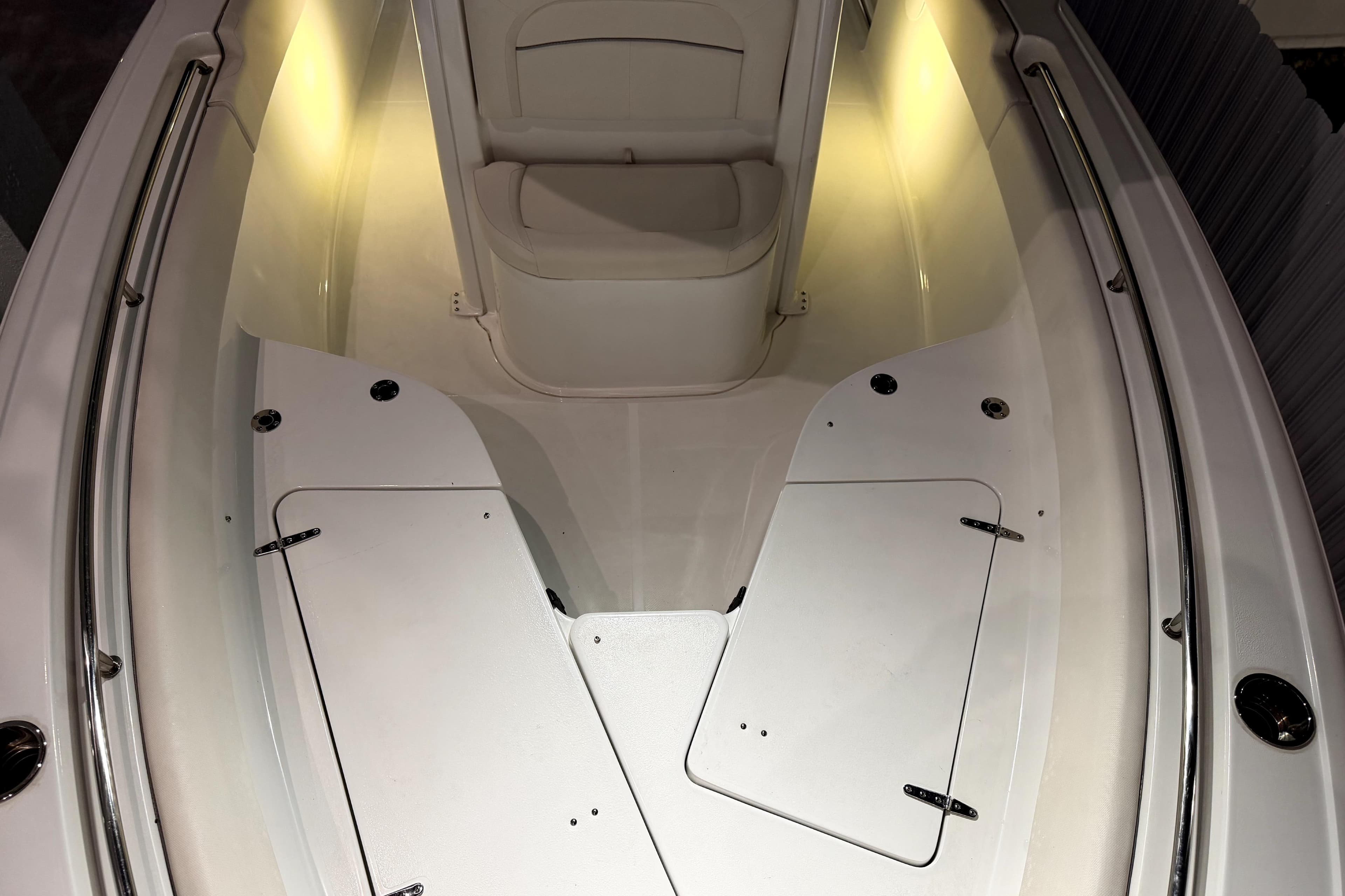 2024 Sea Hunt Ultra 239 SE boat interior with illuminated seating and storage compartments.