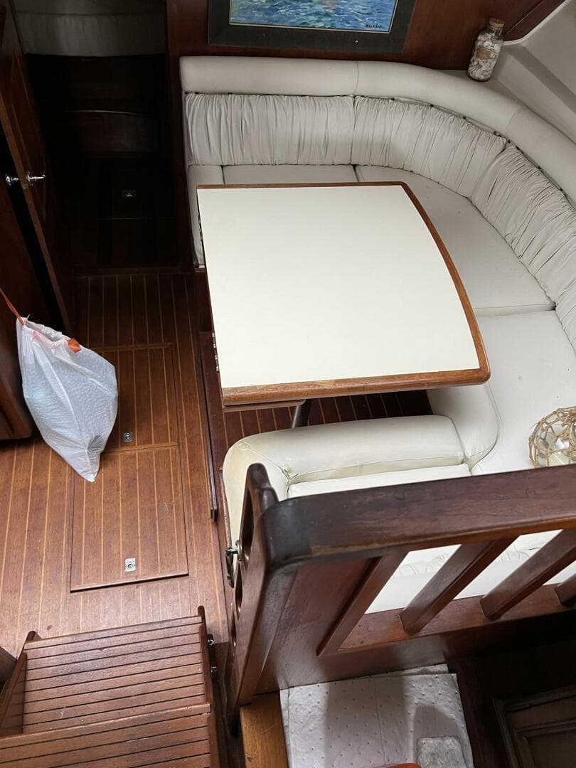 1987 Californian 42 Motor Yacht interior with wooden flooring and cushioned seating area.