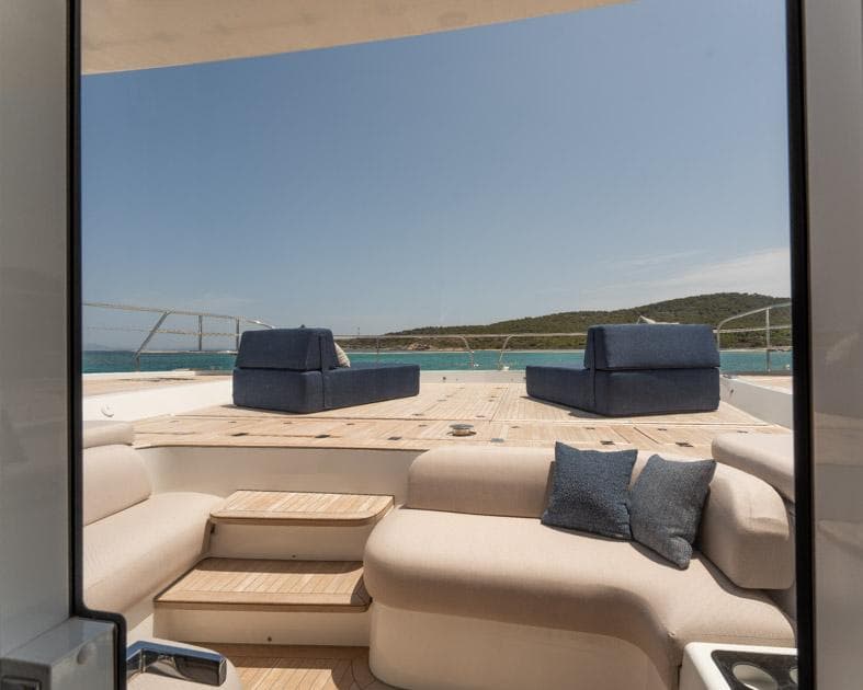 Luxurious 2023 Lagoon 67 yacht deck with plush seating and ocean view.