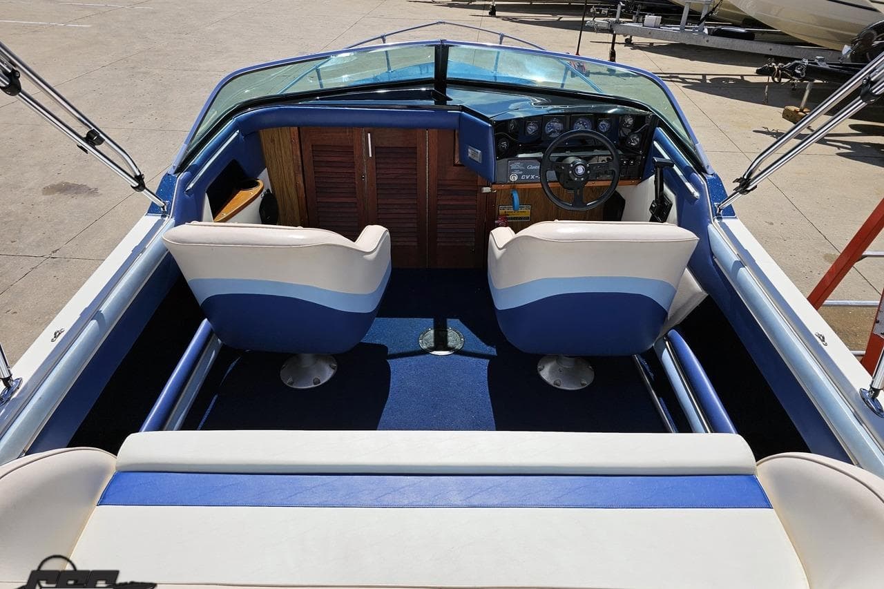 1988 Glastron/Carlson CVX-23 boat interior with blue and white seating and dashboard.